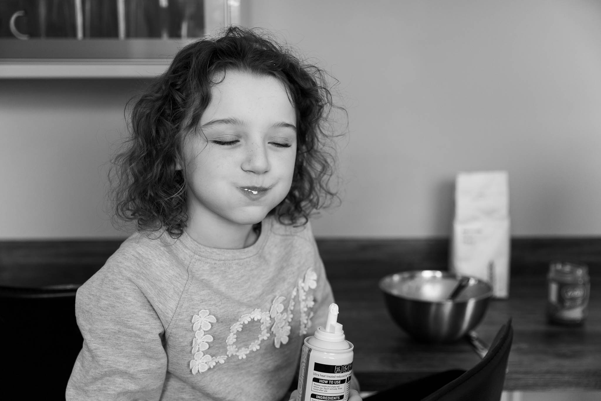 little girl with mouth full of food