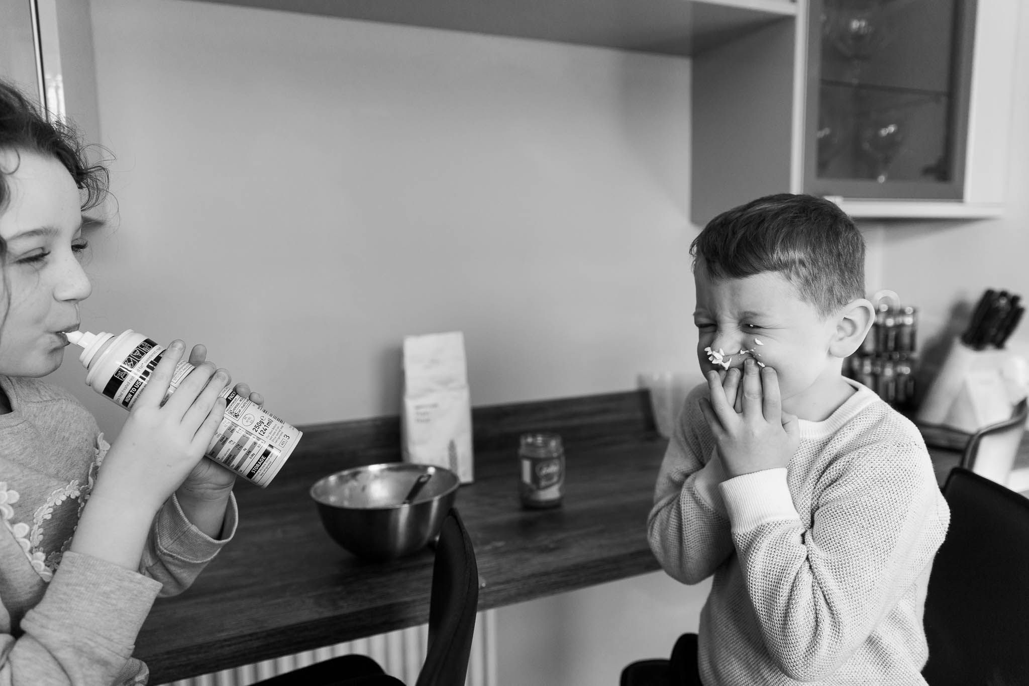 little boy with squirty cream on his face