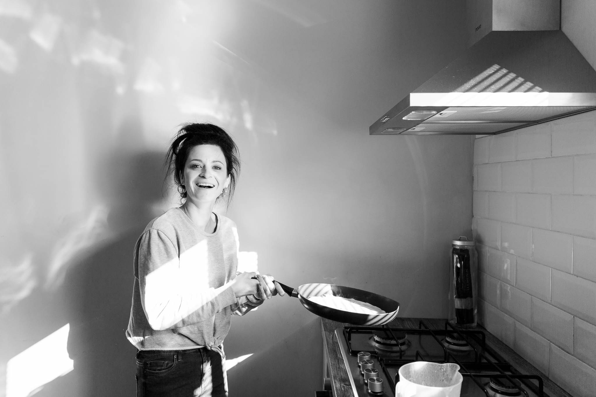 mum flipping pancakes at home
