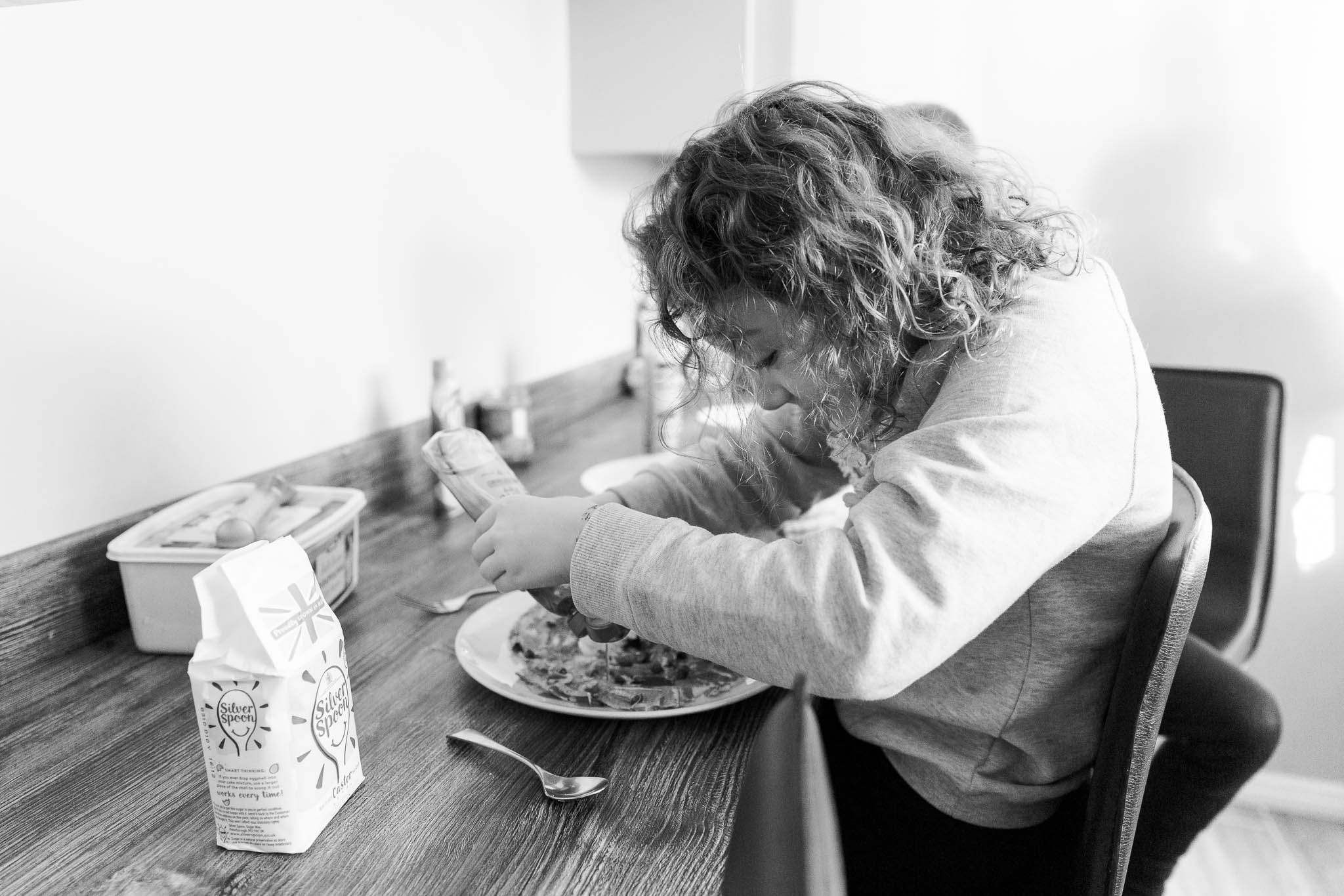 little girl decorating her pancake