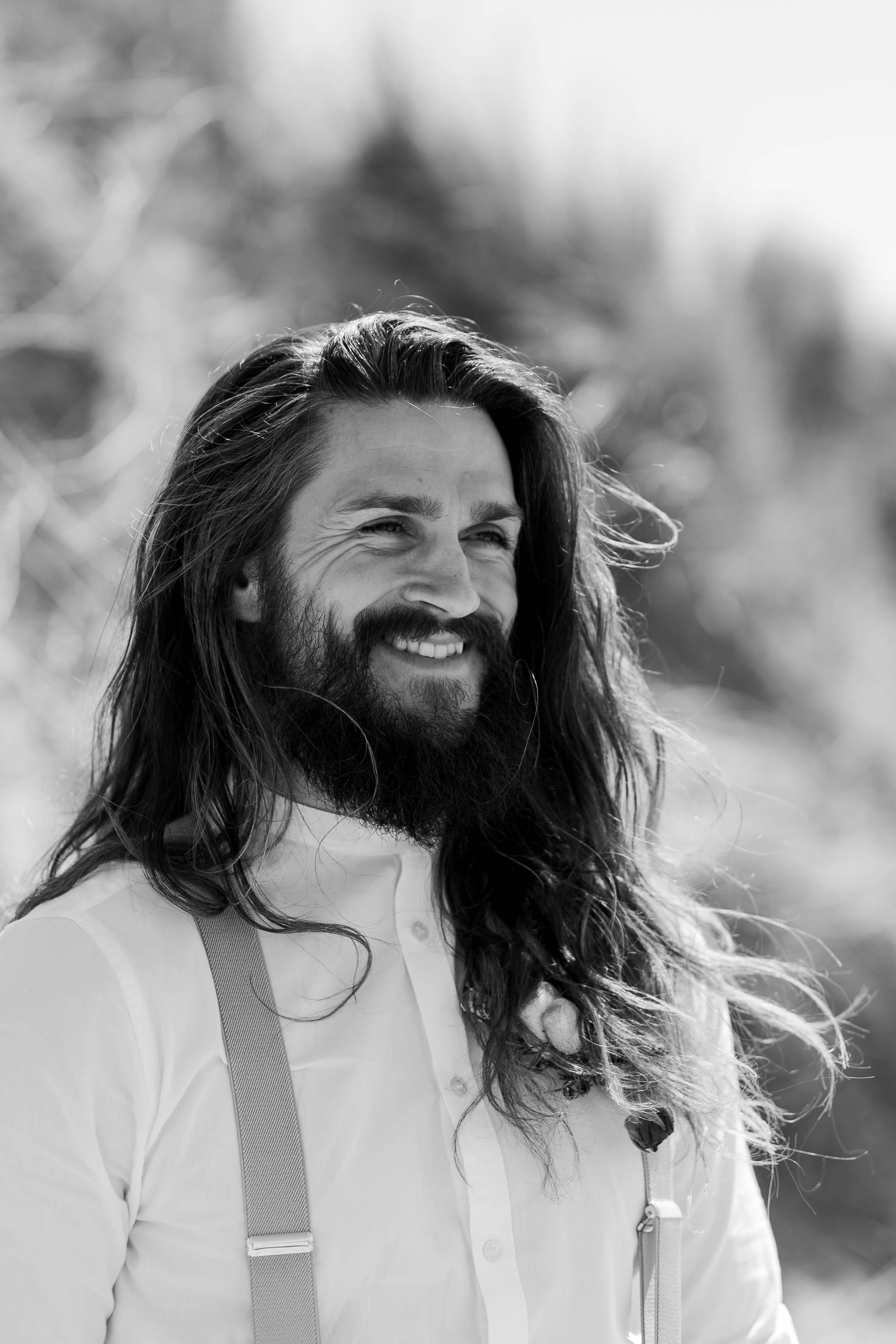 groom with long hair smiling