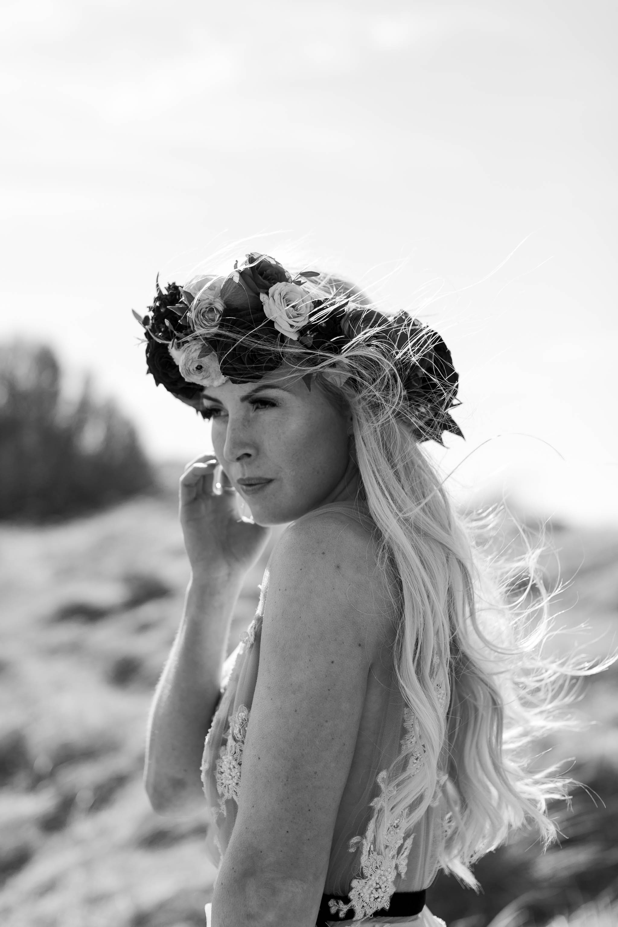 bride wearing flower crown at the beach