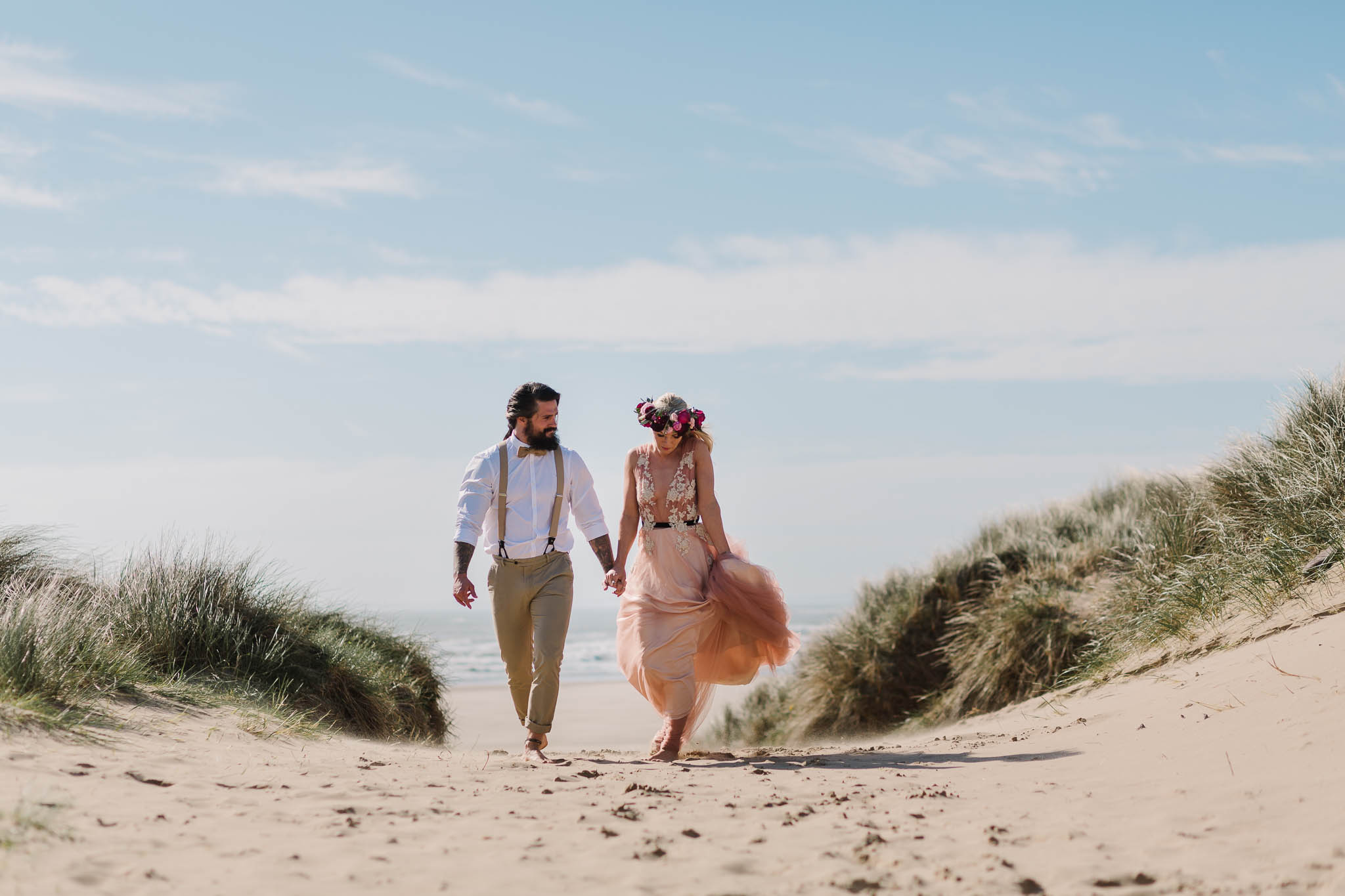 bride and groom walking on the beach