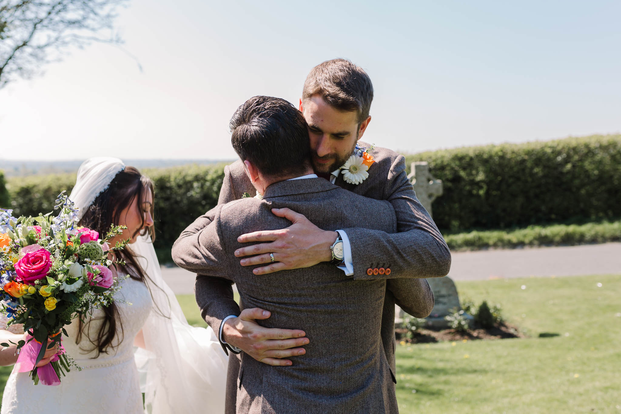 groom hugging guest