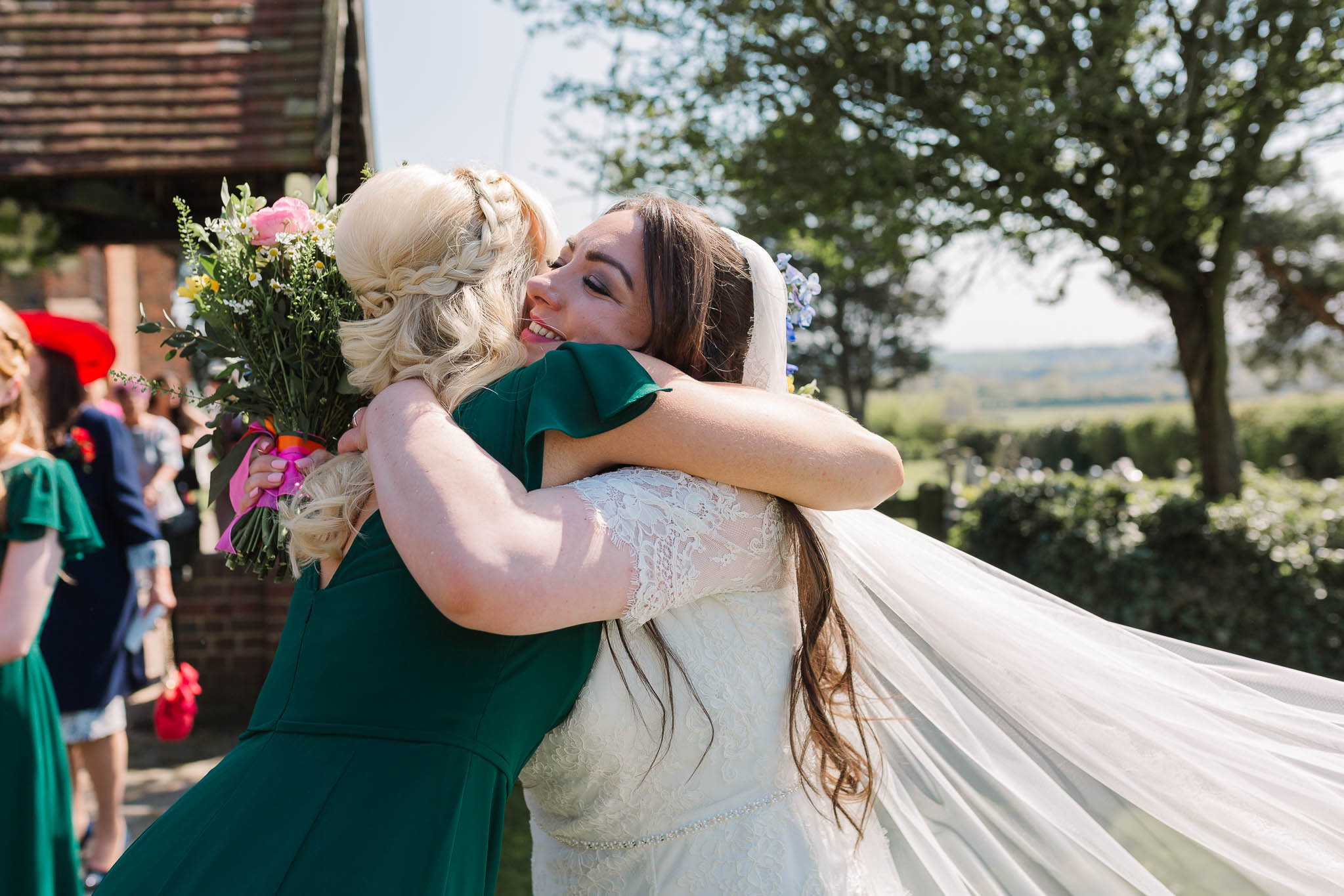 bride hugging bridesmaid