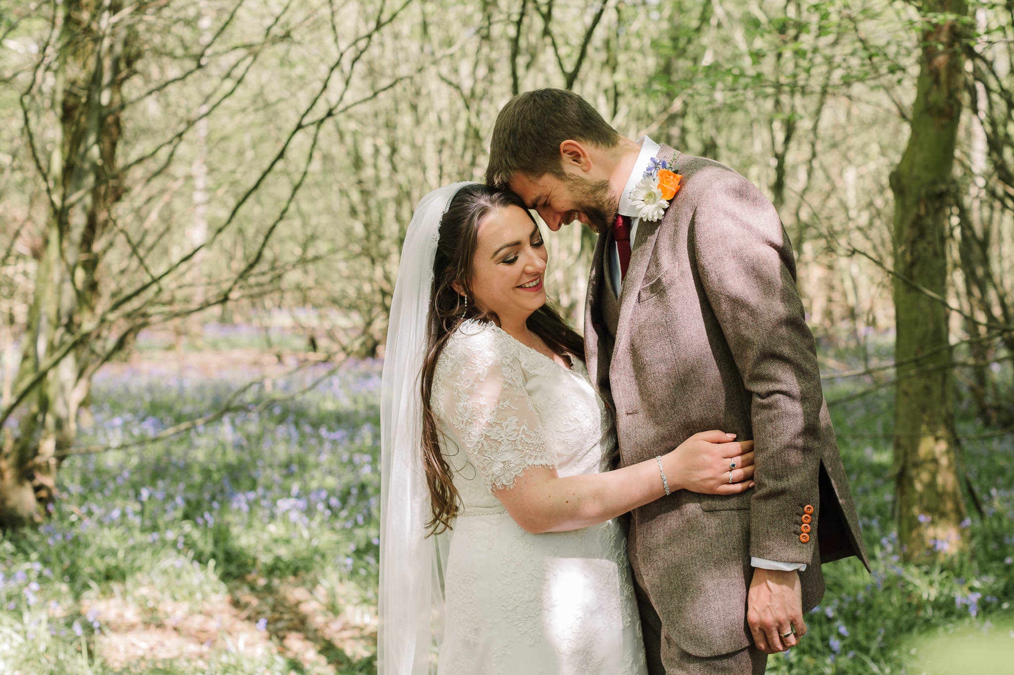 bride and groom in bluebells
