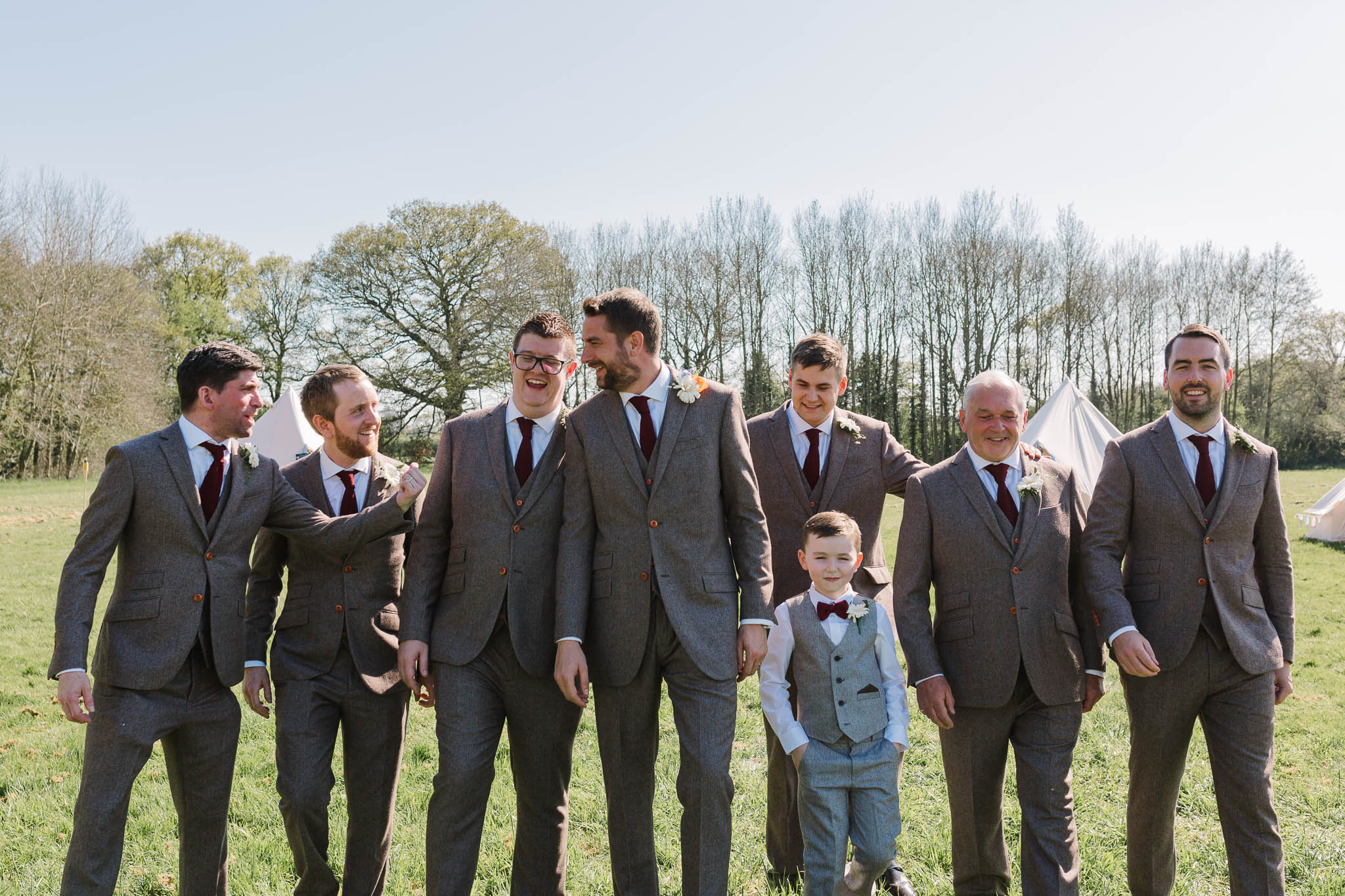groom and groomsmen walking at tipi wedding