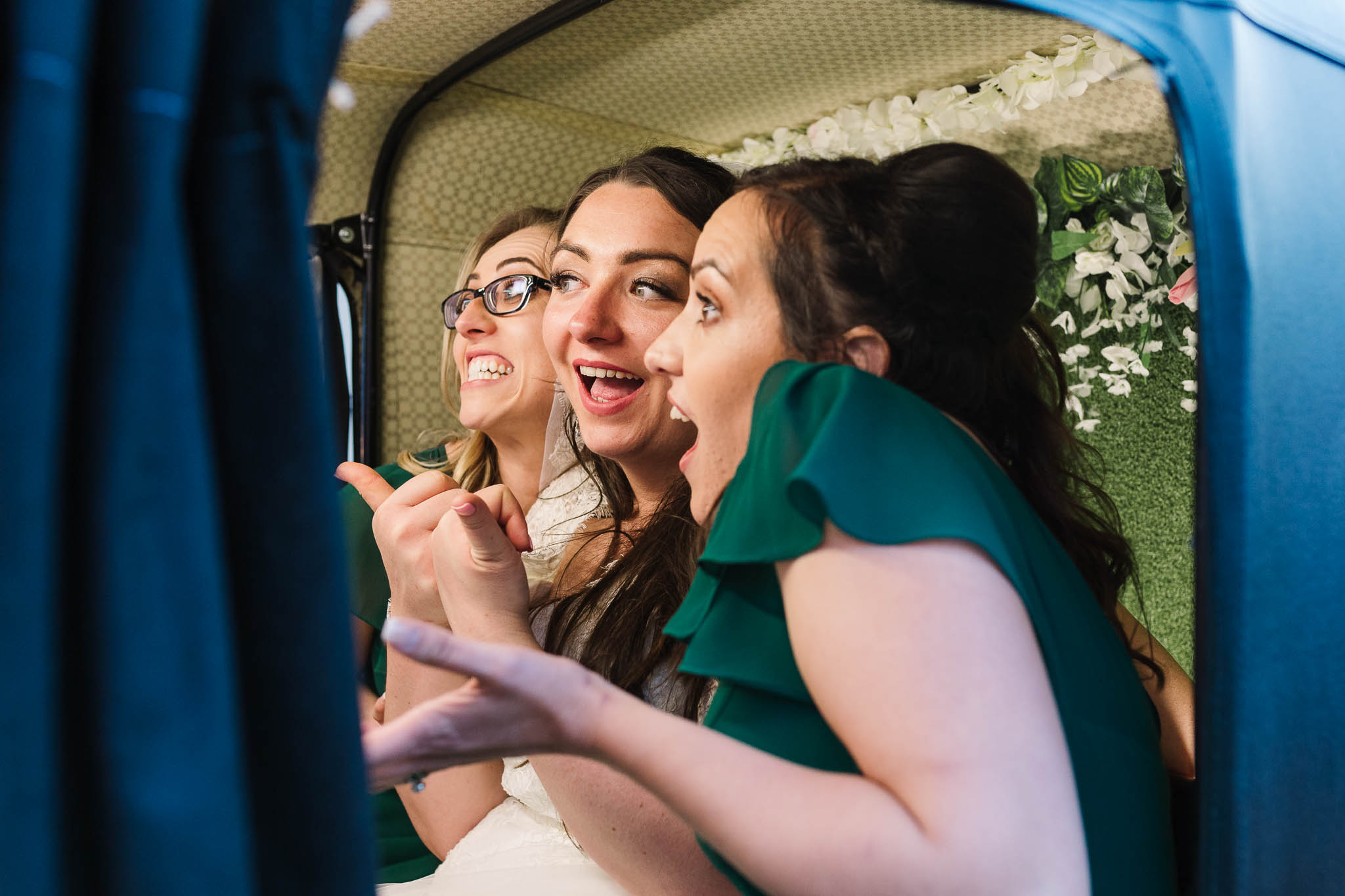 bride and her friends being silly in photo booth