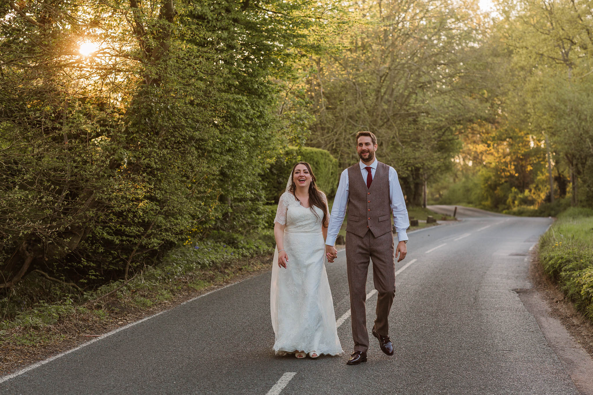 bride and groom laughing at sunset