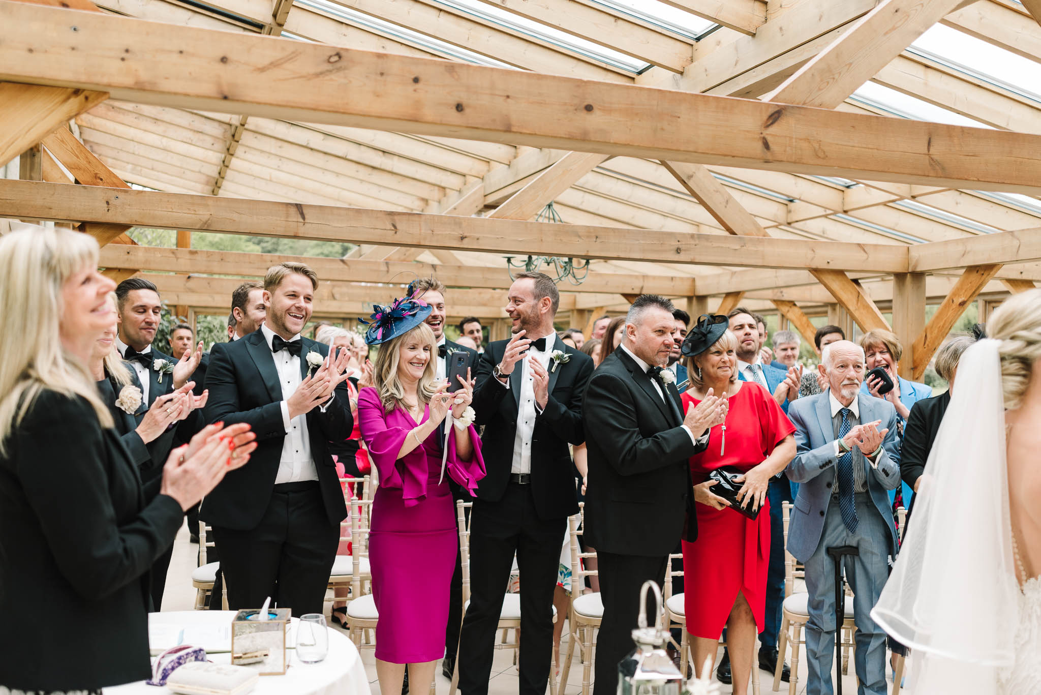 wedding guests clapping during ceremony