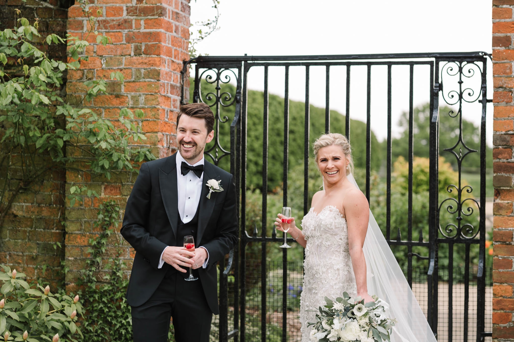 bride and groom laughing in gardens