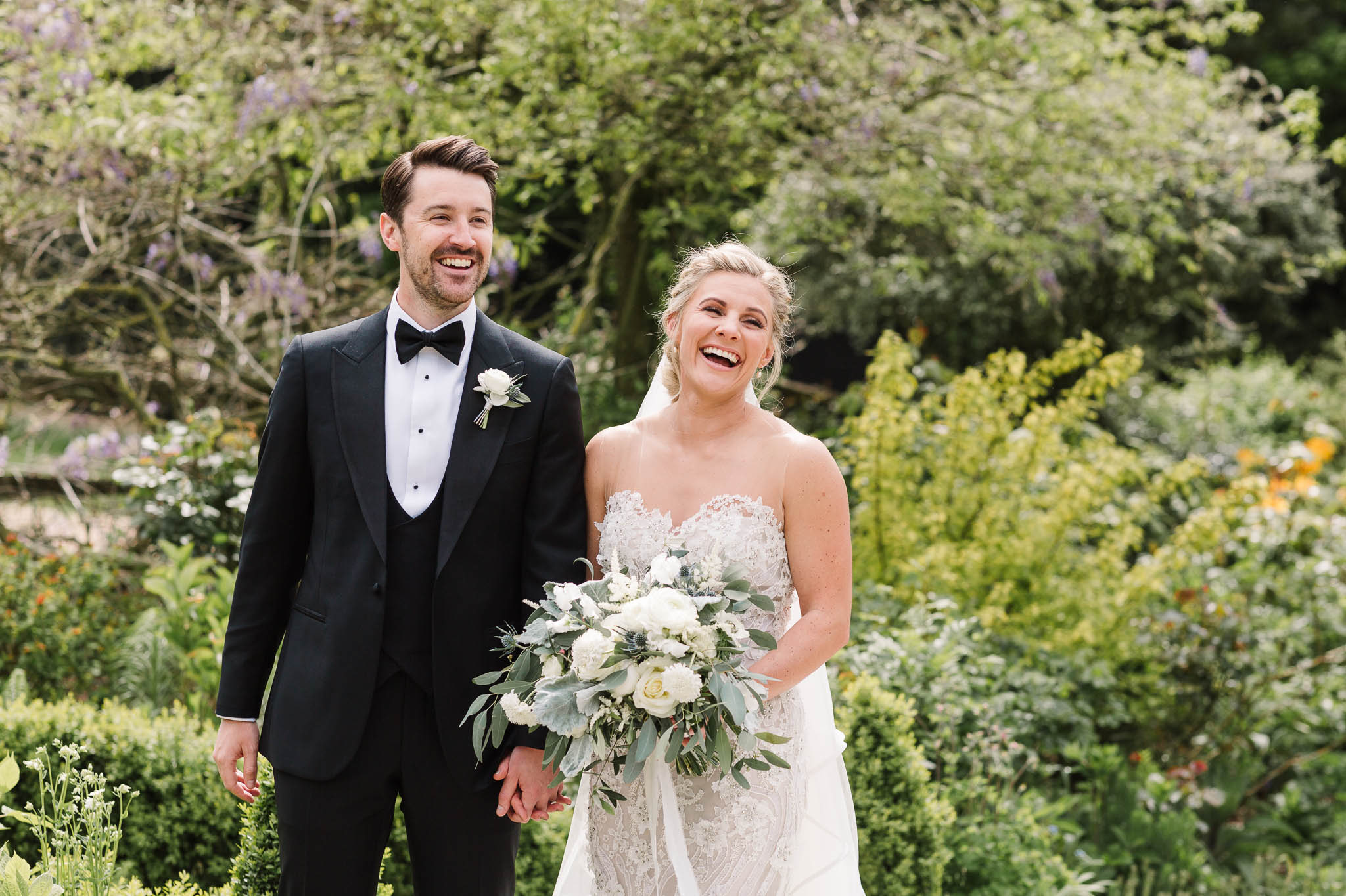 bride and groom laughing in gardens