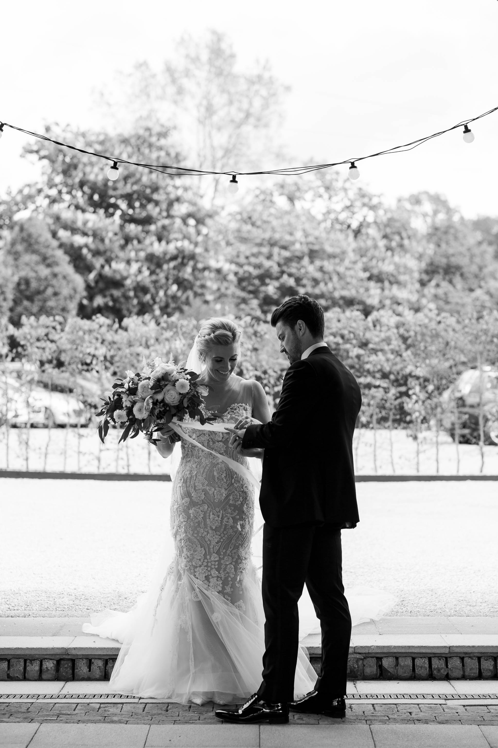 groom looking at brides ring