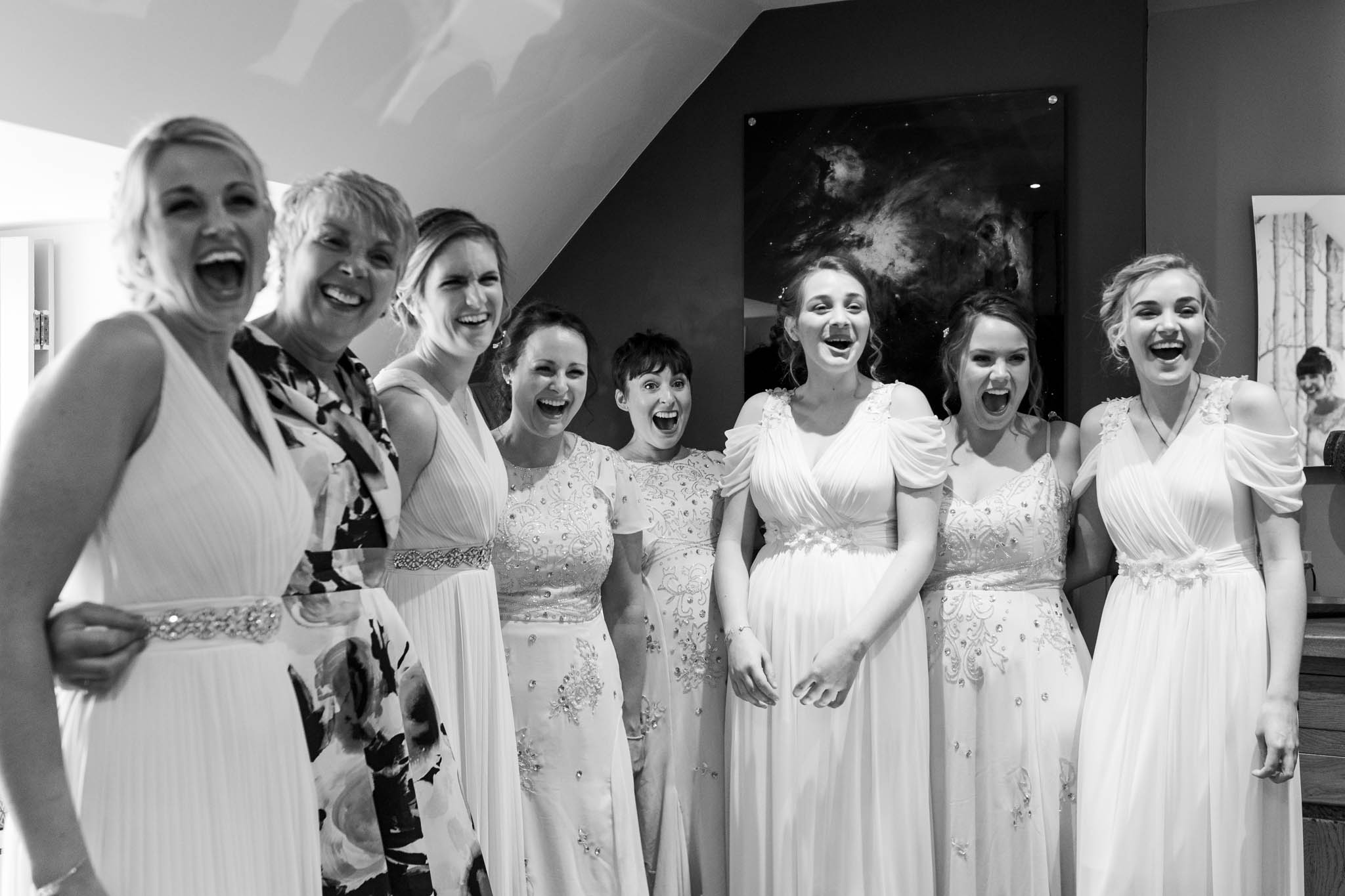 bridesmaids looking shocked and excited when they see the bride