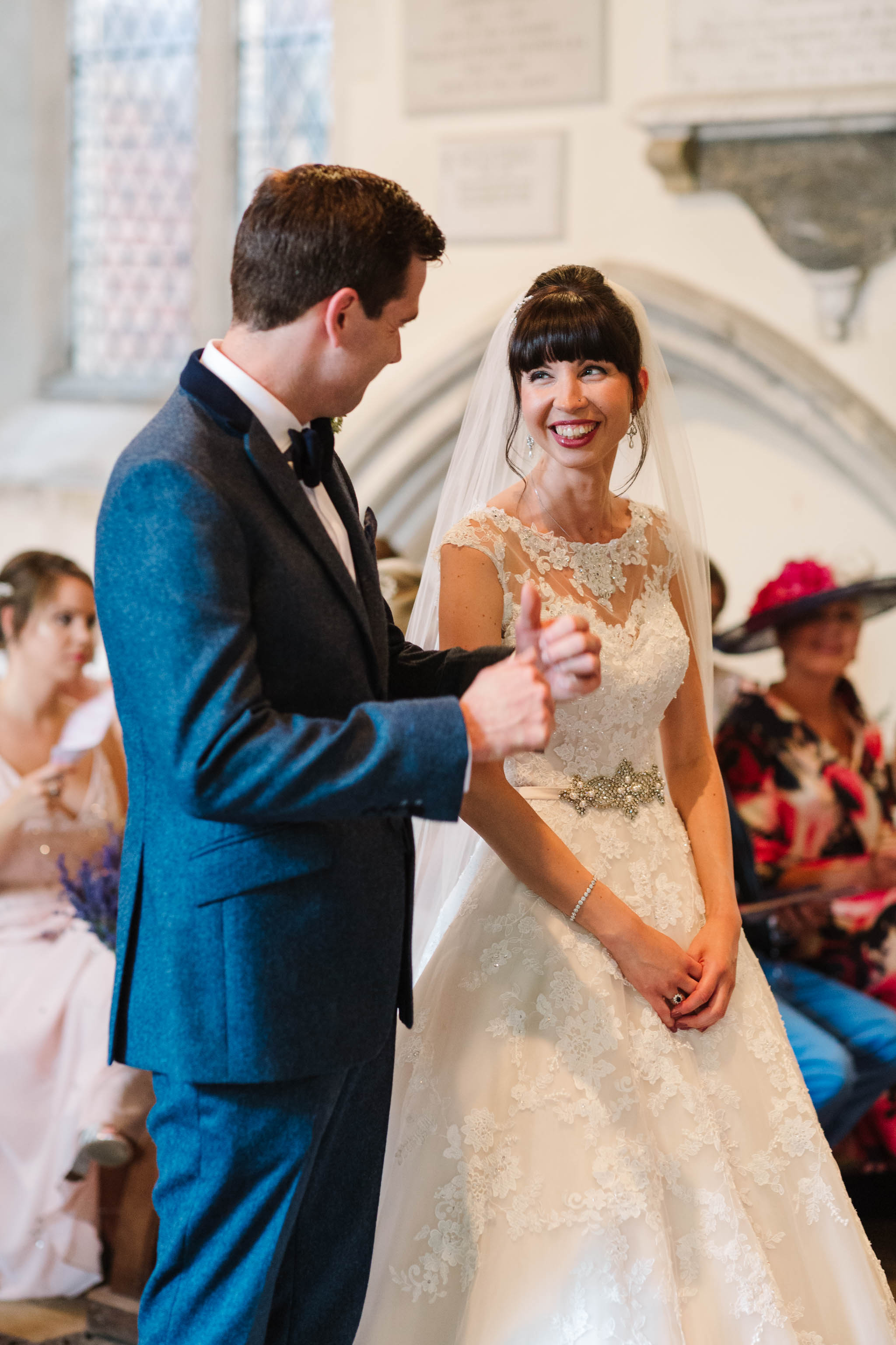bride and groom laughing during church service