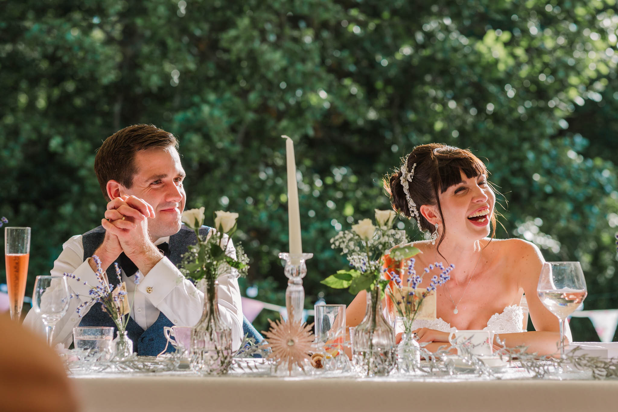 bride and groom laughing at speeches