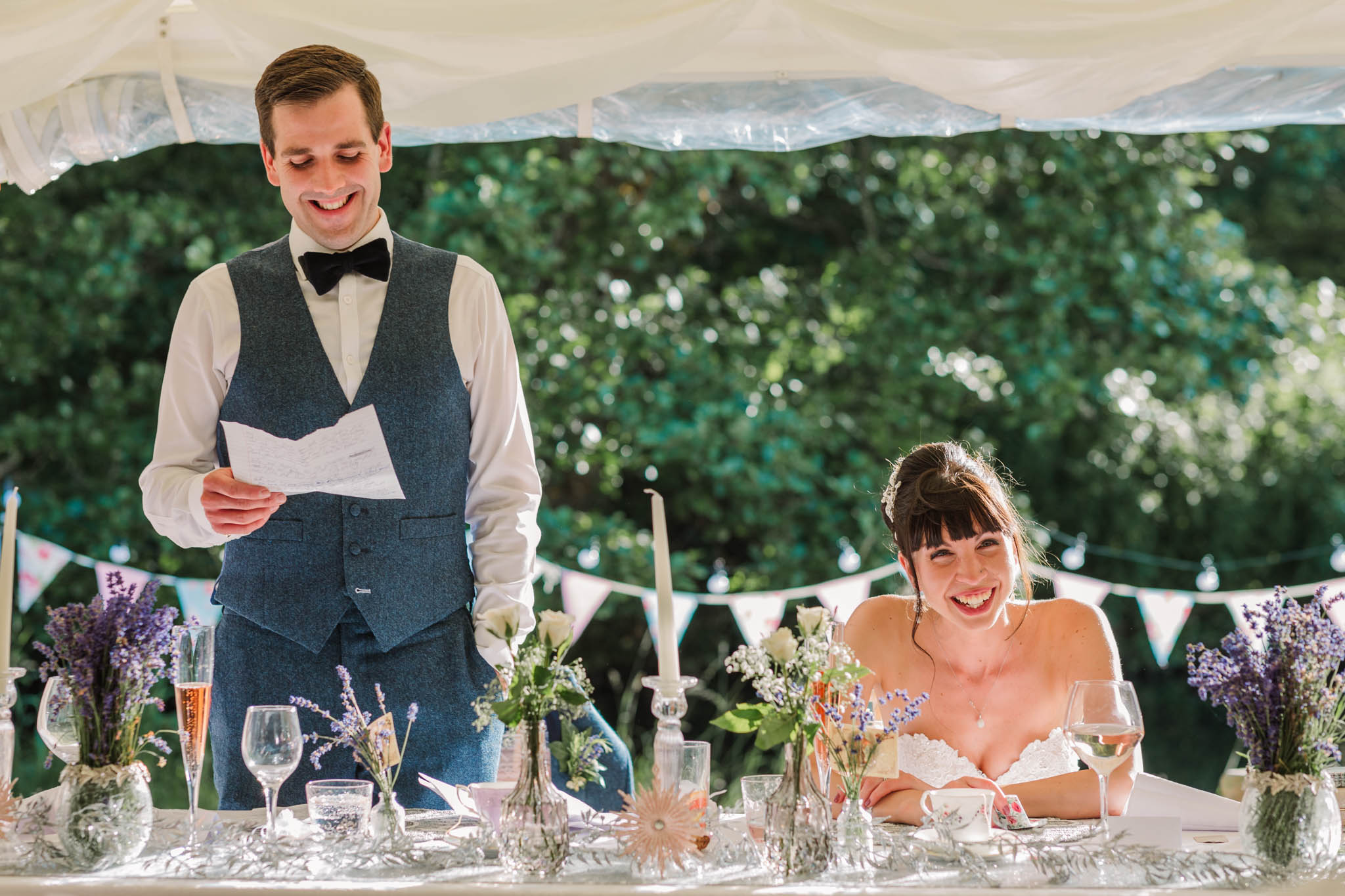 groom giving speech and wife laughing