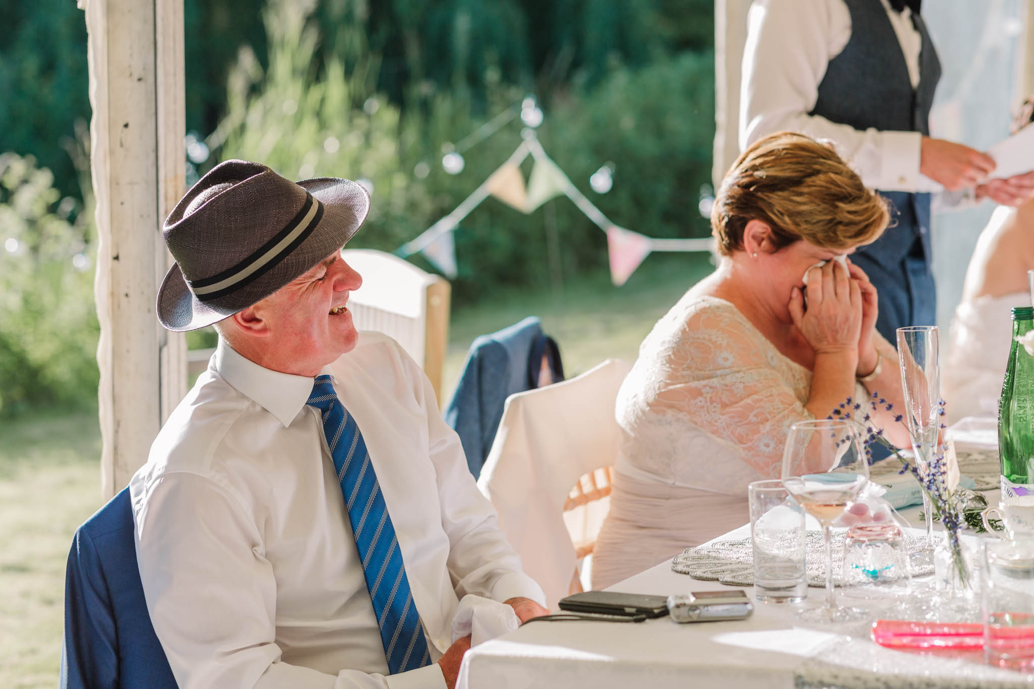 parents laughing and crying at wedding speeches