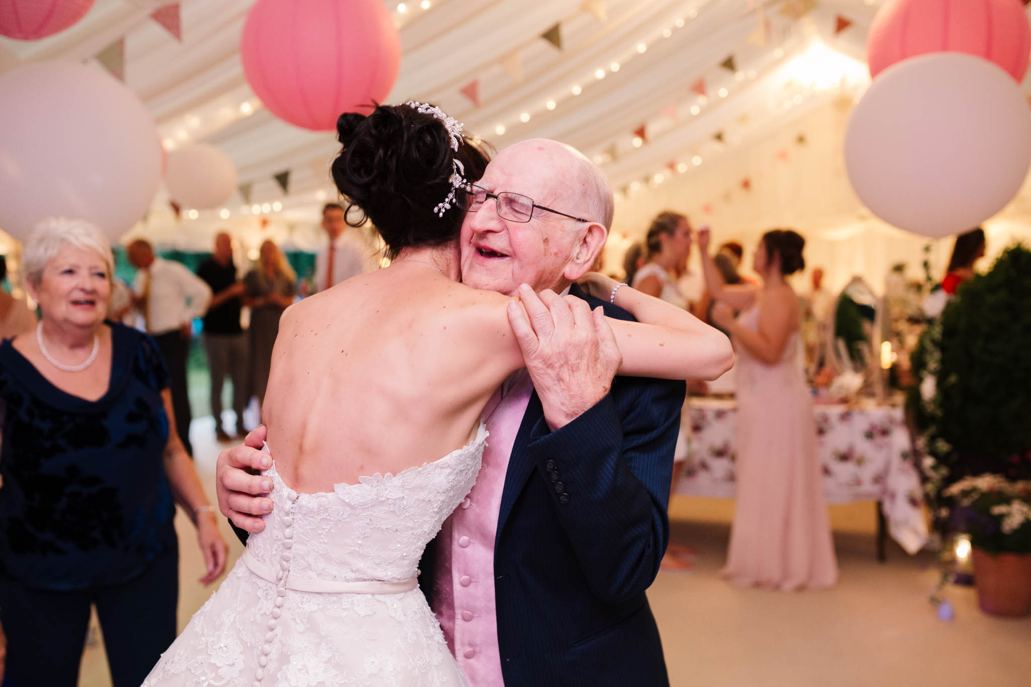 bride hugging grandad on dance floor