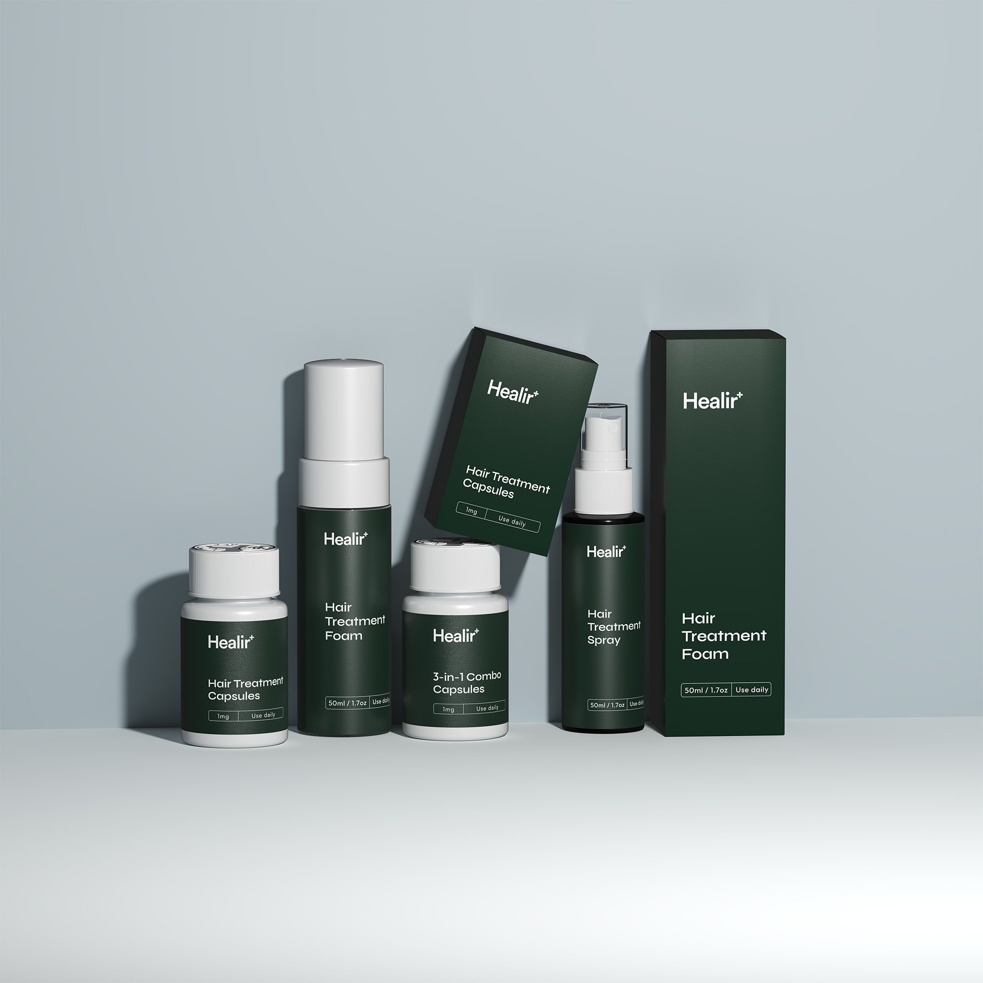 Collection of dark green and white hair treatment products, including capsules, foam, spray, and boxes, arranged on a light gray surface.