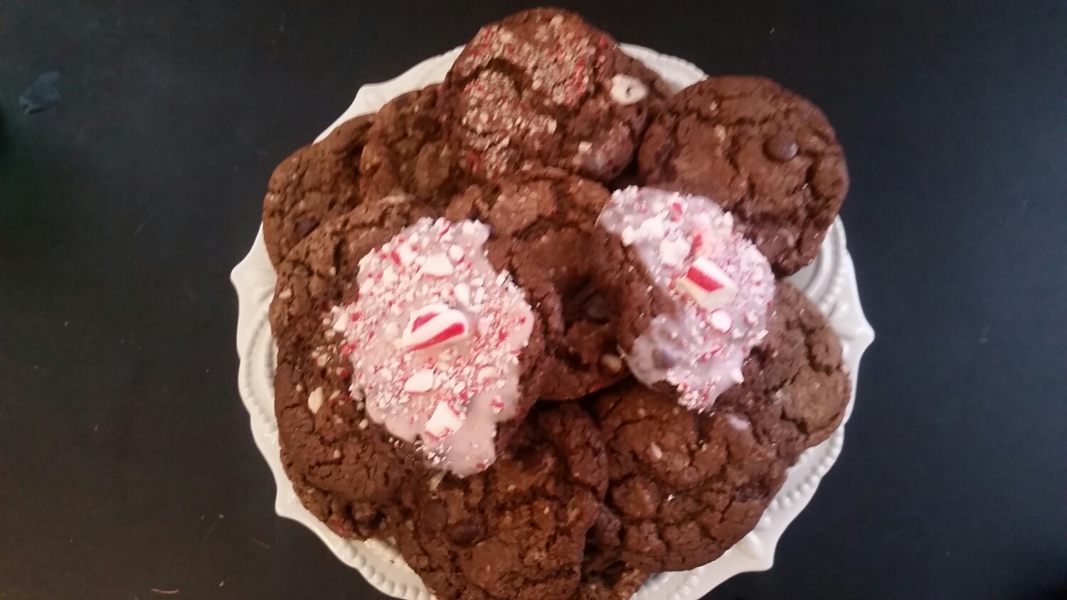 Decadent chocolate chip cookies with crushed peppermint chips and a candied peppermint glaze