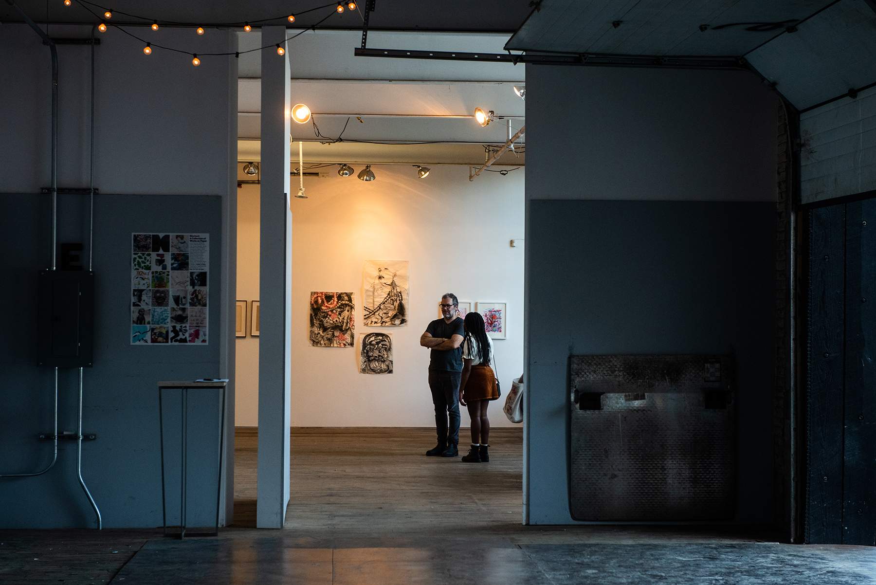 Curator and artist James Gallagher, left, and artist Eden Lynch, of Los Angeles, talk at Atlas Studios during Newburgh Open Studios on Saturday.