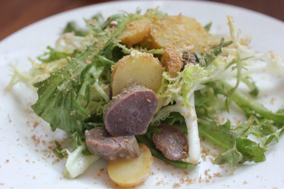 frisee salad with potatoes and hosue made mortadella