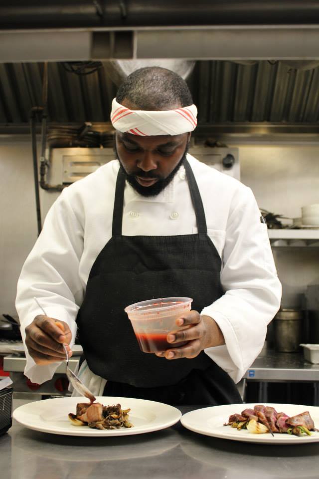 Sous Chef Omar Tate plating food in the kitchen at Runner &amp; stone