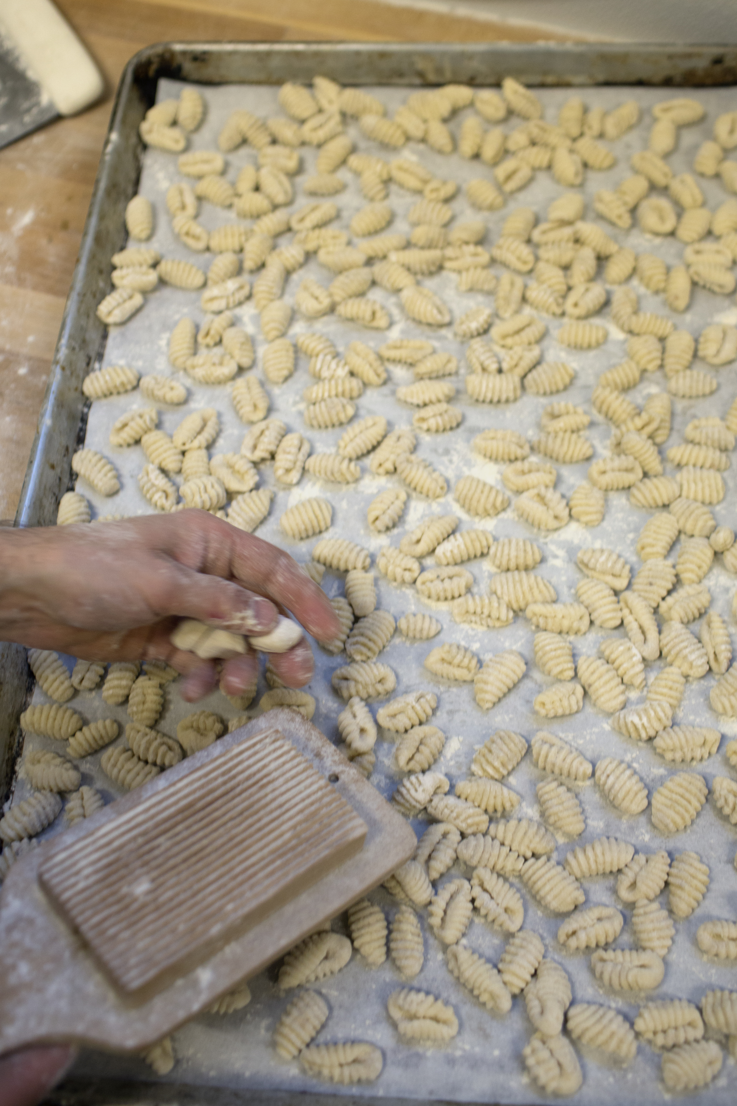 head baker peter endriss shaping potato gnocchi in the bakery at runner and stone