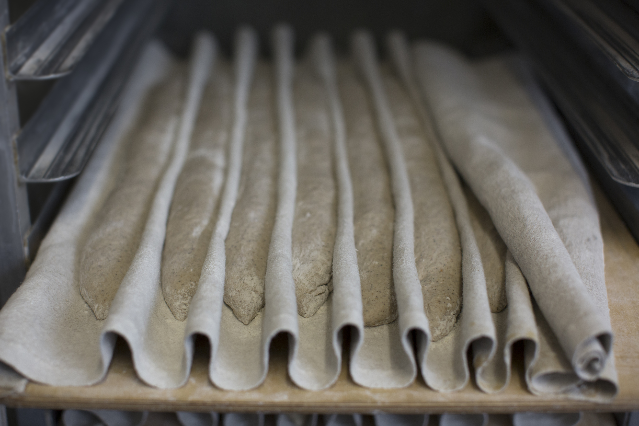 buckwheat baguettes proofing on a couch in the runner &amp; stone bakery
