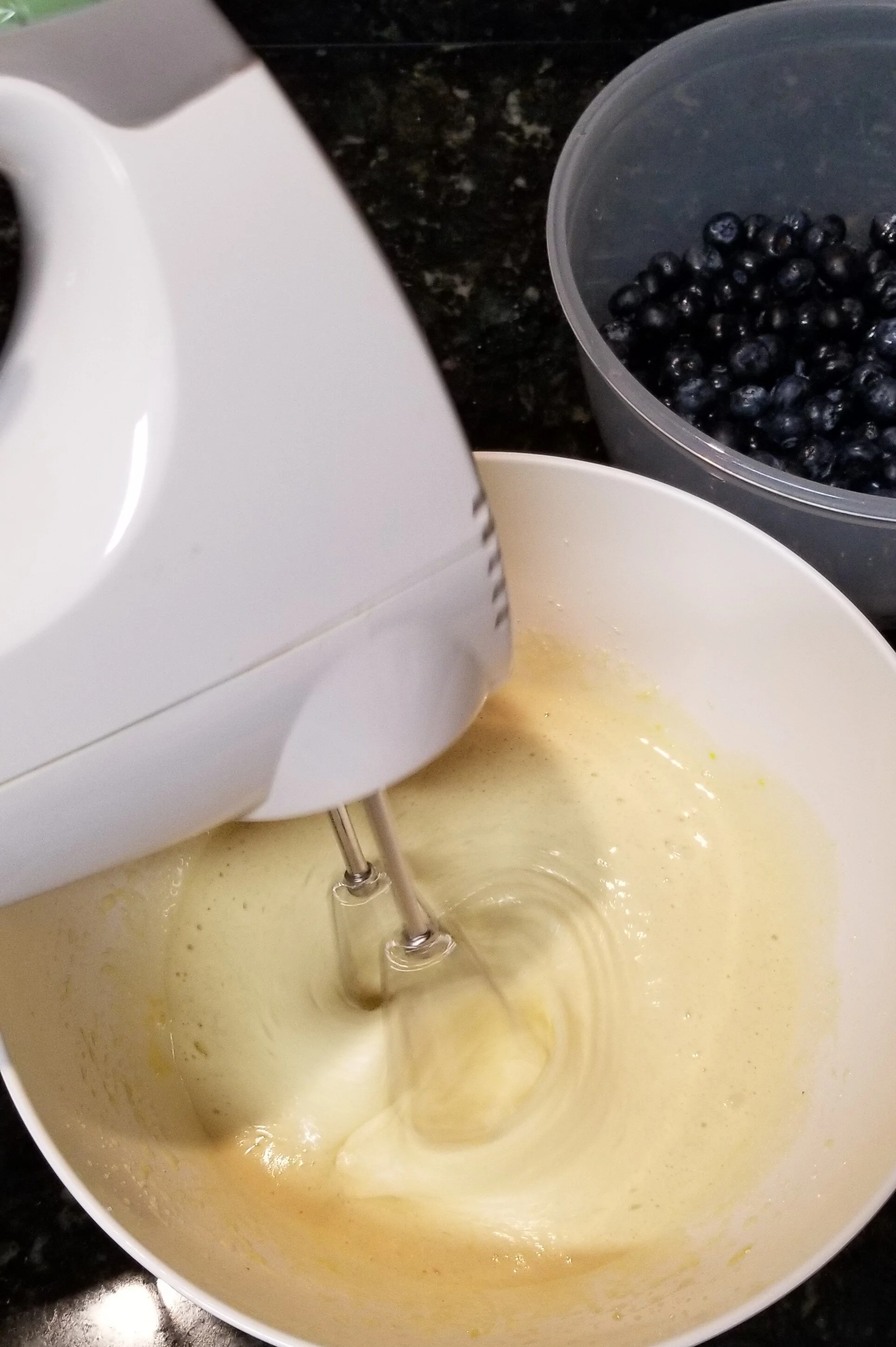 electric mixer mixing eggs and sugar