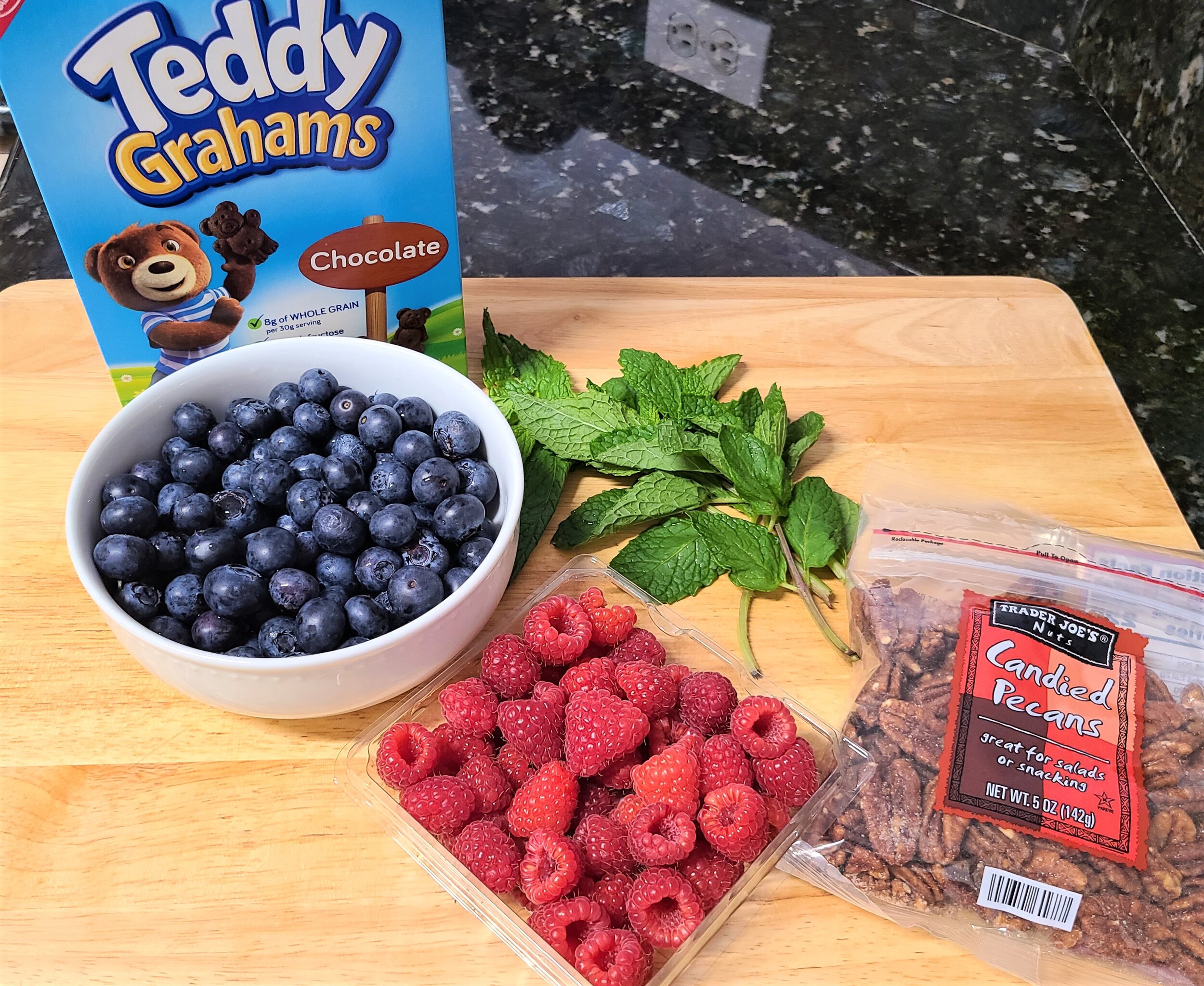 blueberries, strawberries, almonds, teddy grahams, and mint