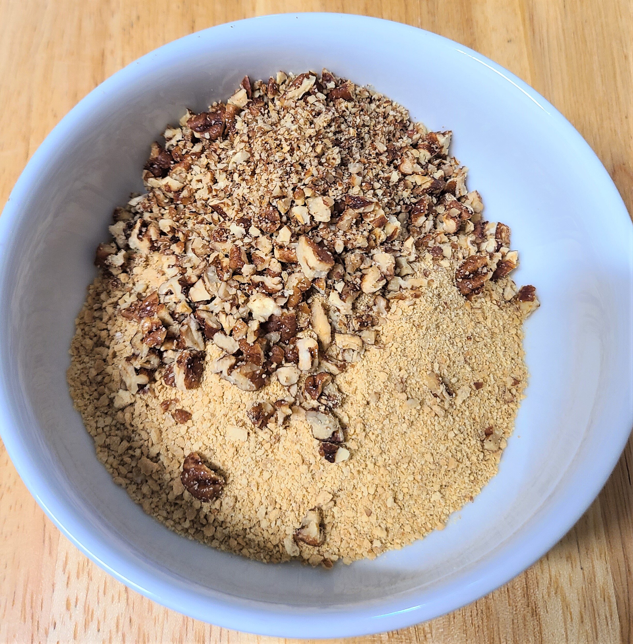 crushed graham crackers and almonds in a white bowl