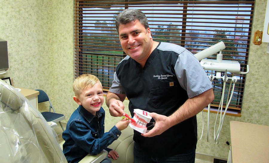 kid with dentures and dentist