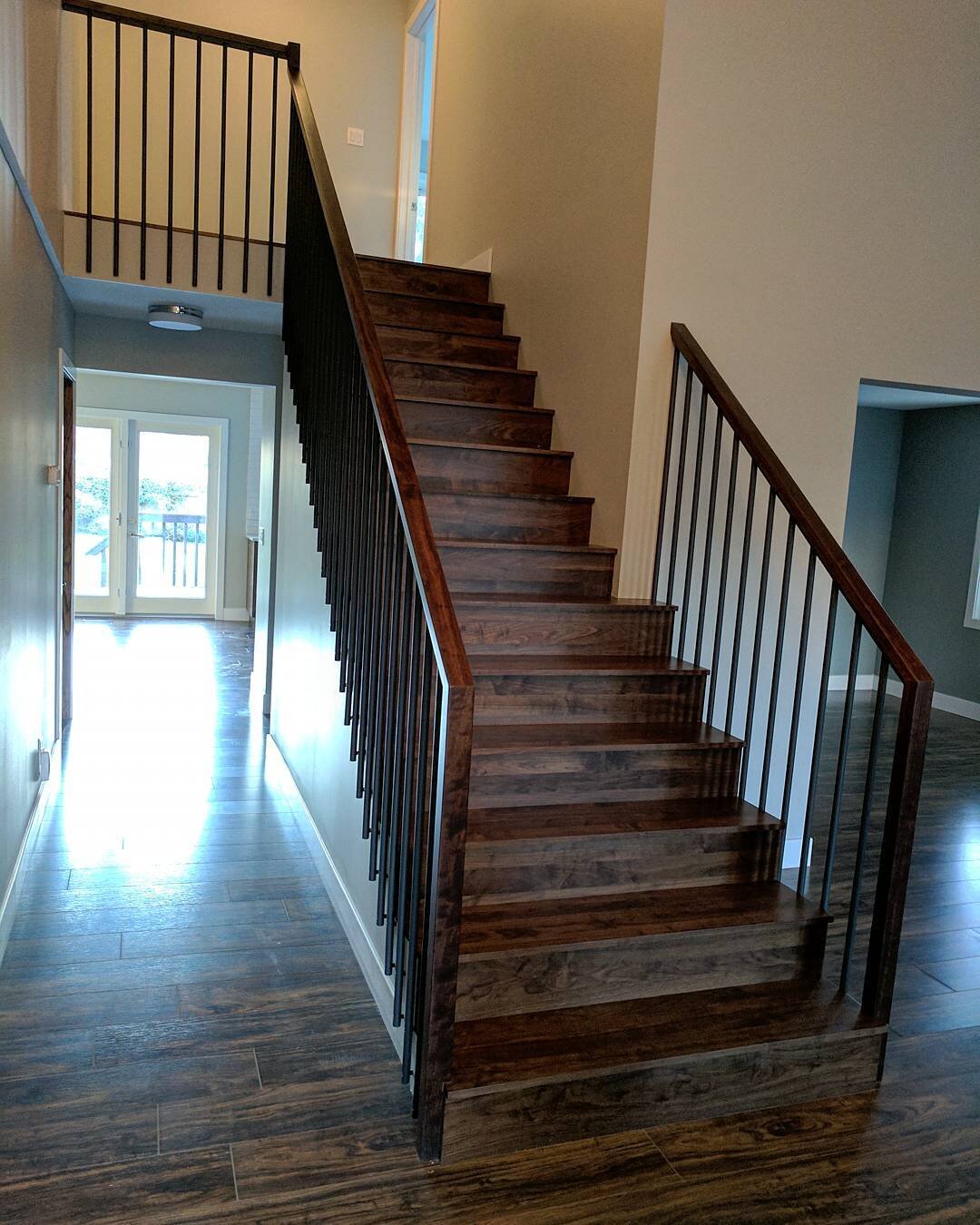 This is a beautiful Walnut stair we worked on with @havenbuilders right in the heart of City Park. So fun to try something new and see it far exceed our expectations. Solid Walnut tread covers with minimalist style rail and spindles. #stairs #railing