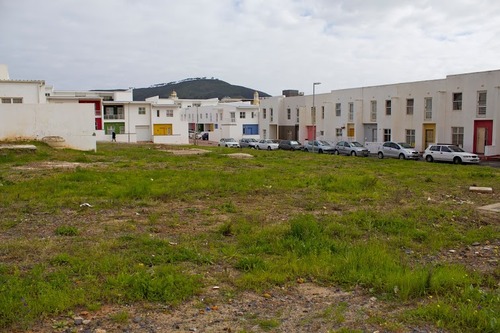 An empty lot behind District Six housing developments. Photo credit: James Leyba