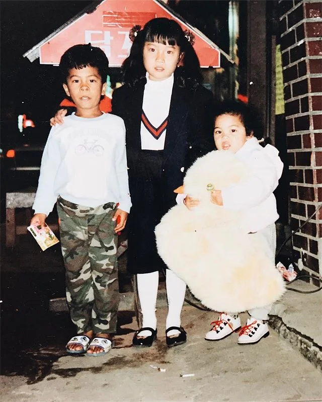 1992: my brother, cousin, and me somewhere in the streets of South Korea. Got myself a duck and a lollipop. #winning Also... I want those shoes. 😍