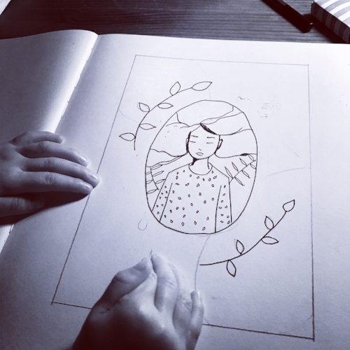 My daughter Ione looking at an inked sketch.