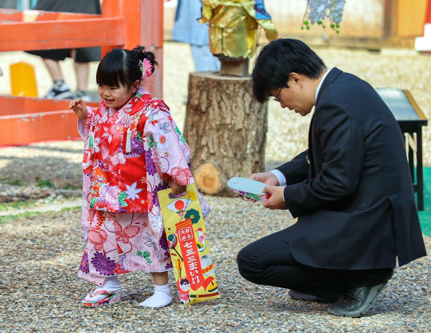 Father trying his best to fix a shoe malfunction, but she doesn&rsquo;t seem to care too much.
