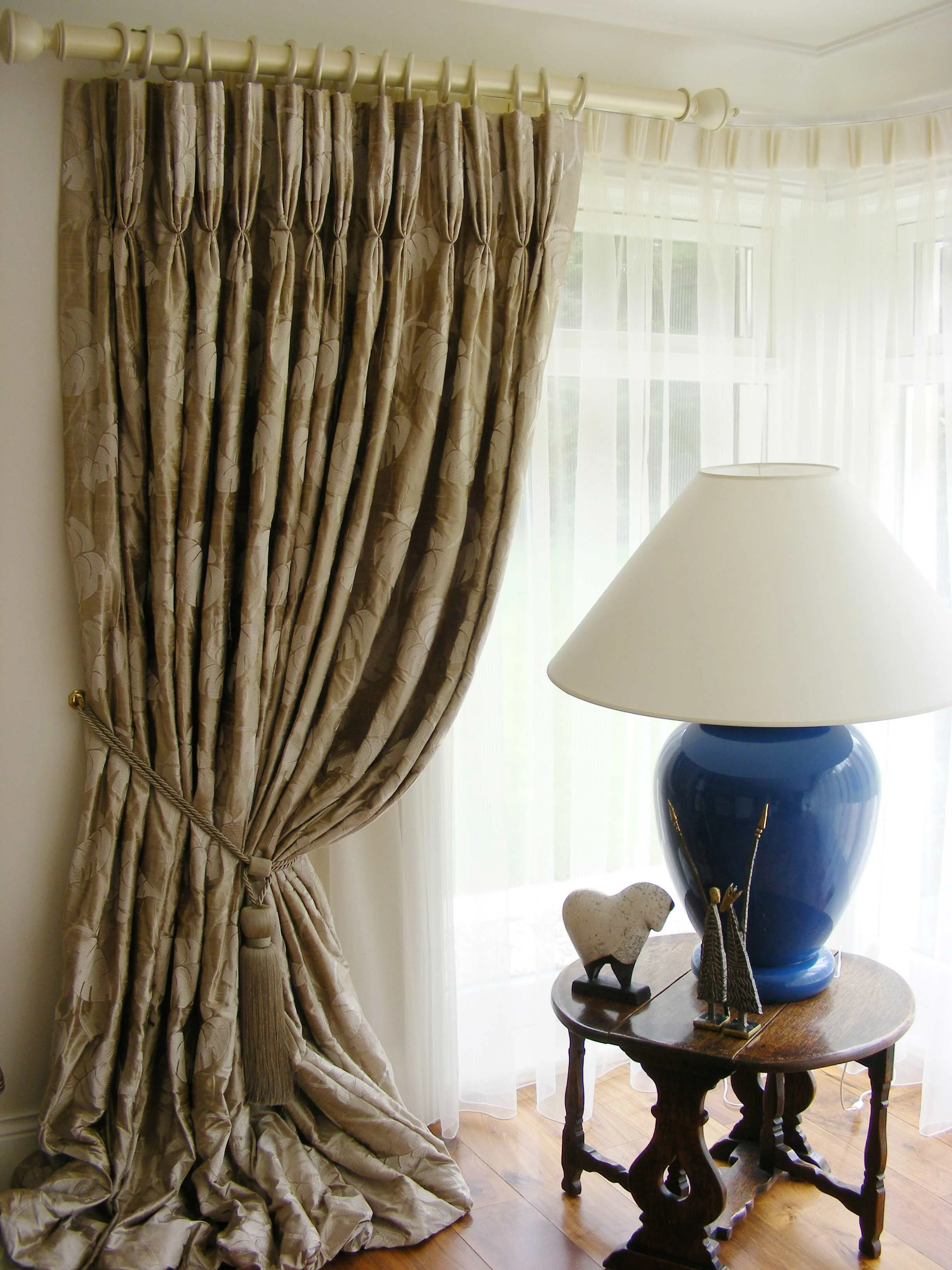 Luxurious Silk Curtain with french pleats hung from ornate pole