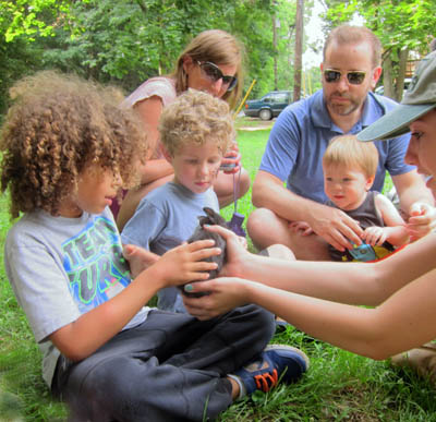 kids interact with bunnies, ducklings, and baby goats from leesburg animal park's traveling baby zoo.