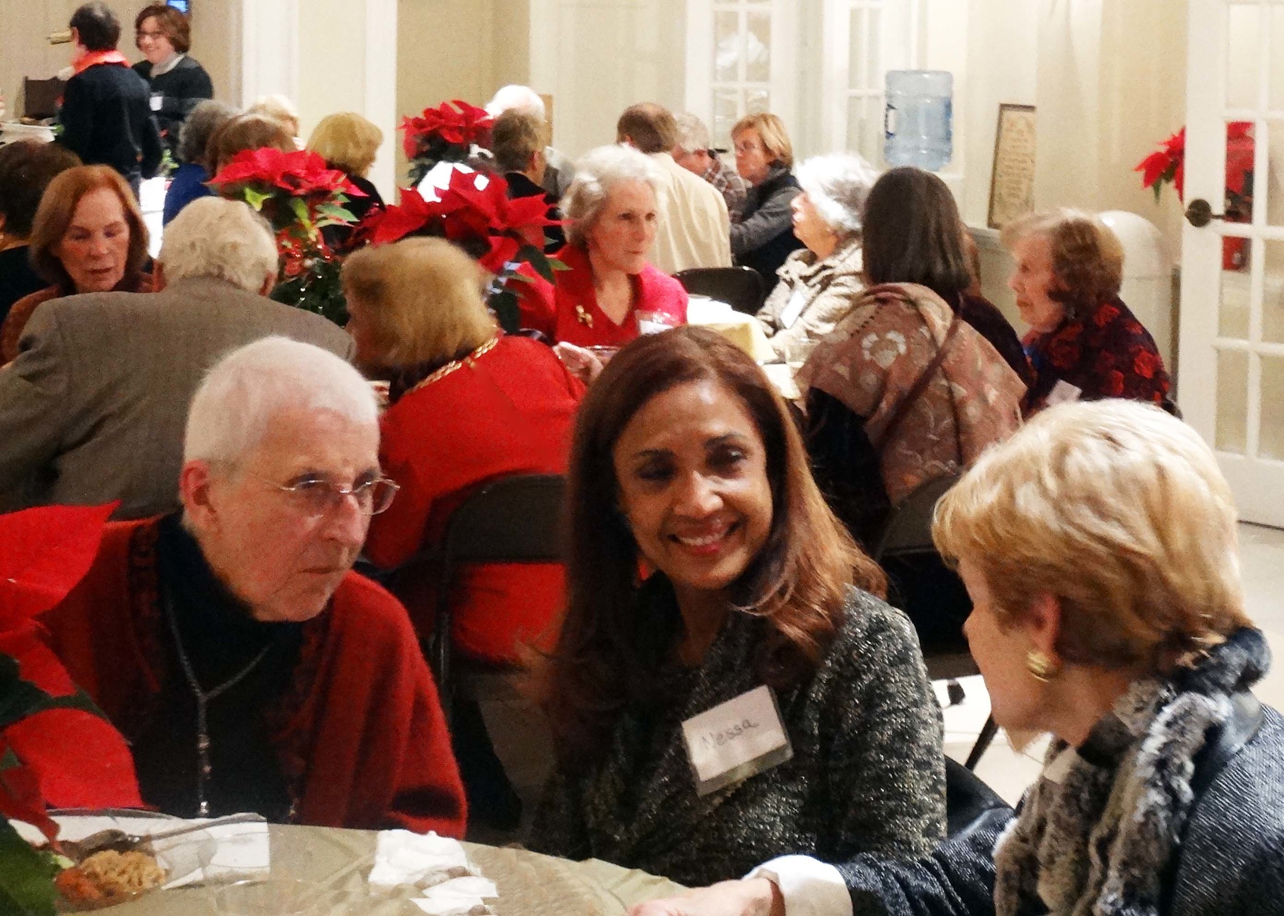 members and volunteers mingle over dinner.