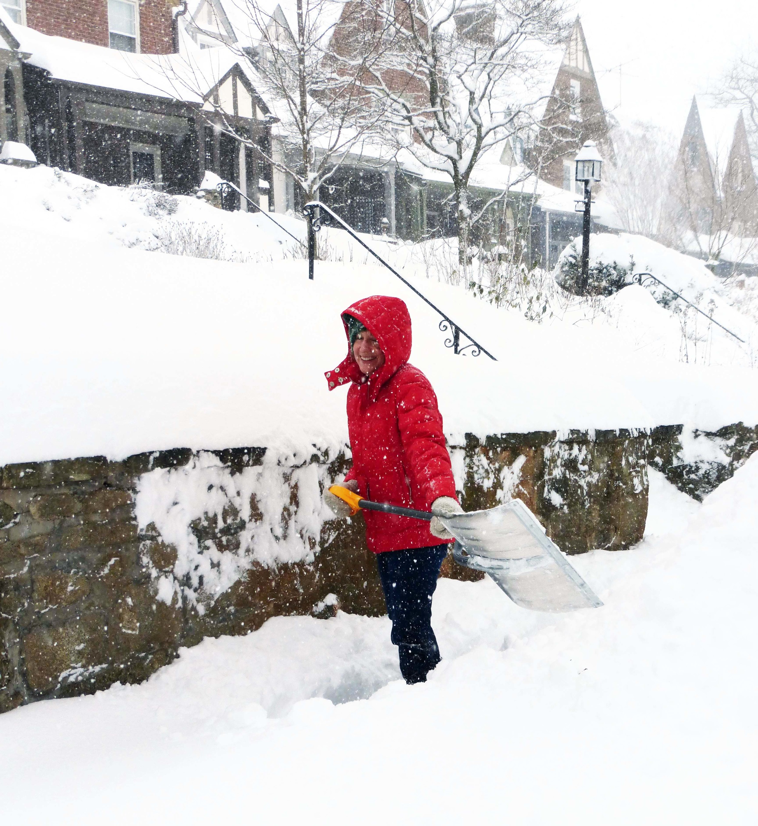 Stacy Davis clears the sidewalk for her neighbor.