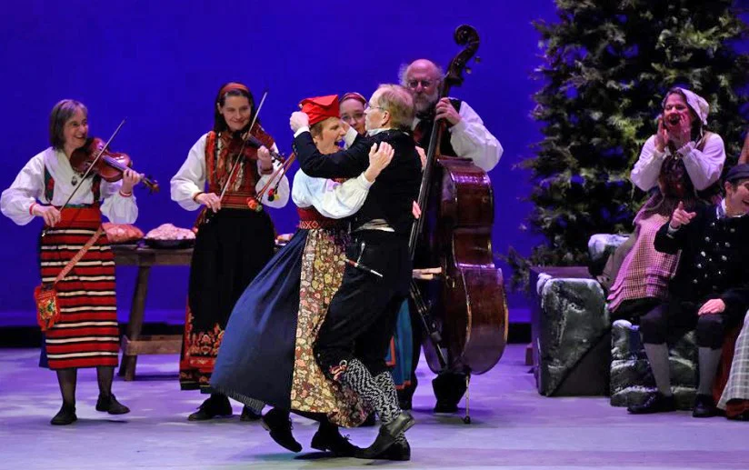 Ross places the red cap on Linda's head during the Klackpolska. Photo by Washington Revels.