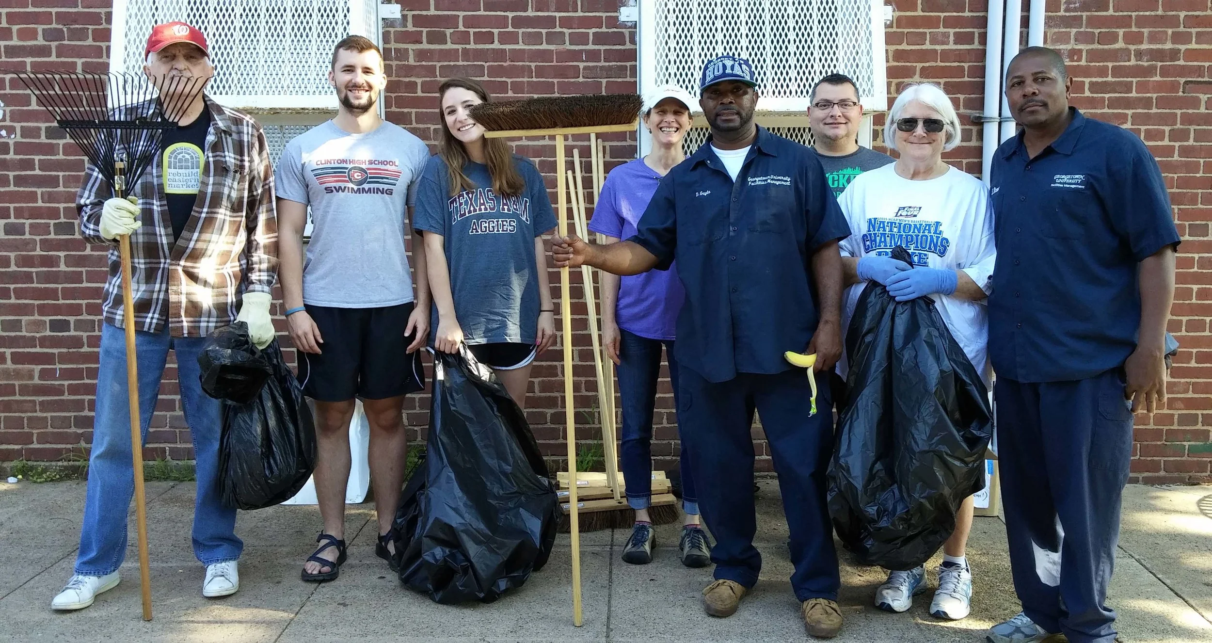 Armed with rakes, brooms, and garbage bags, GU staff and neighbors prepare to go to work.