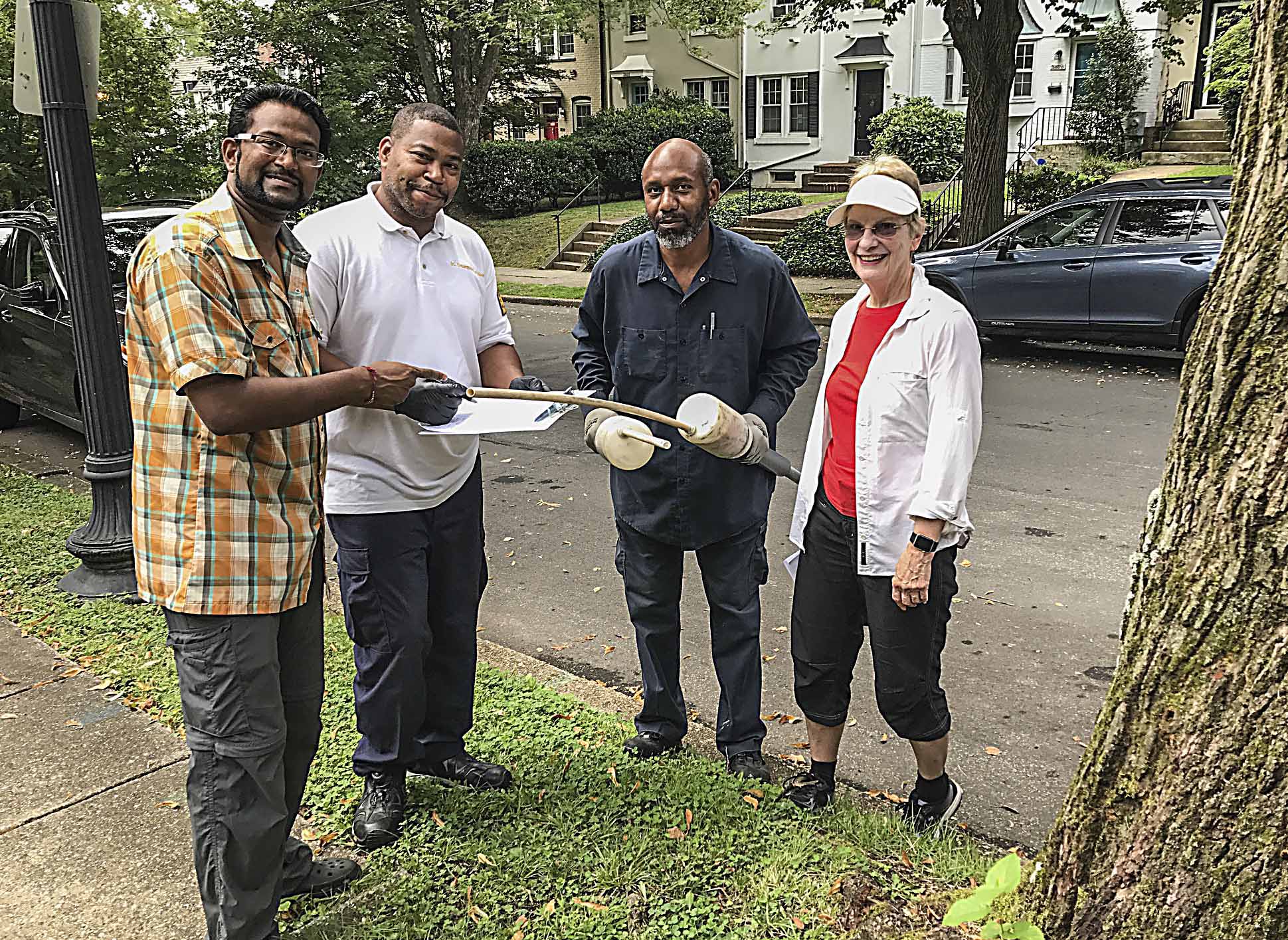 Kishan Putta and Linda Brooks flank two of the four city workers who inspected Burleith properties on August 18. Photos by Ross Schipper.
