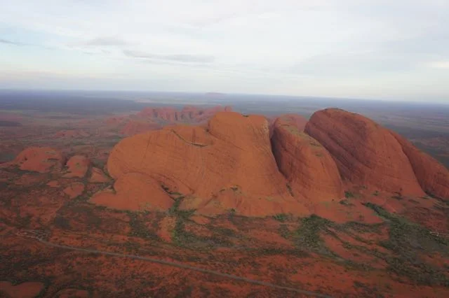 Kata Tjuta from the air -- many heads. Road in foreground give a sense of scale. Pic © author 2017