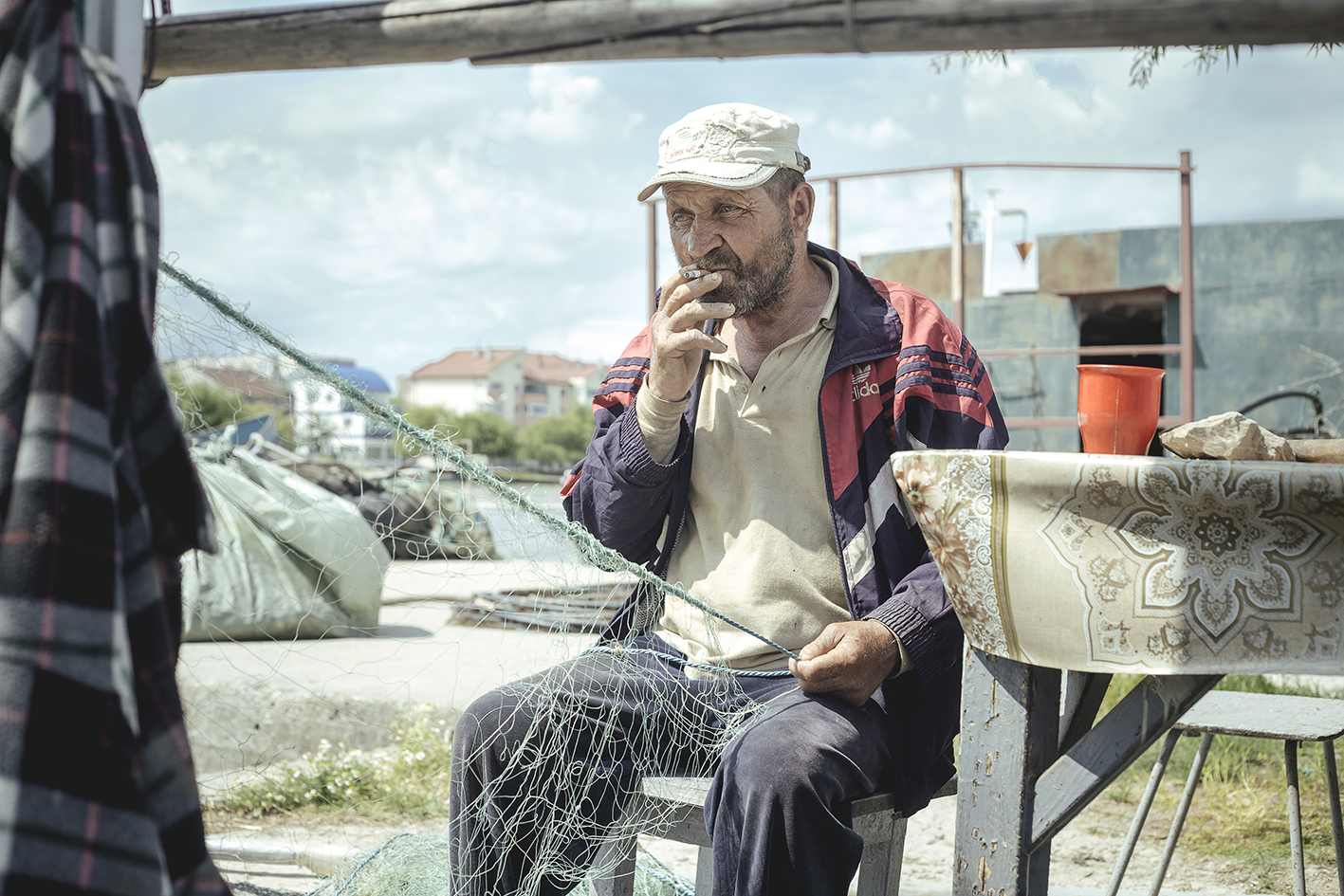 Mending nets, near the fish factory, Sulina, Romania, 2015