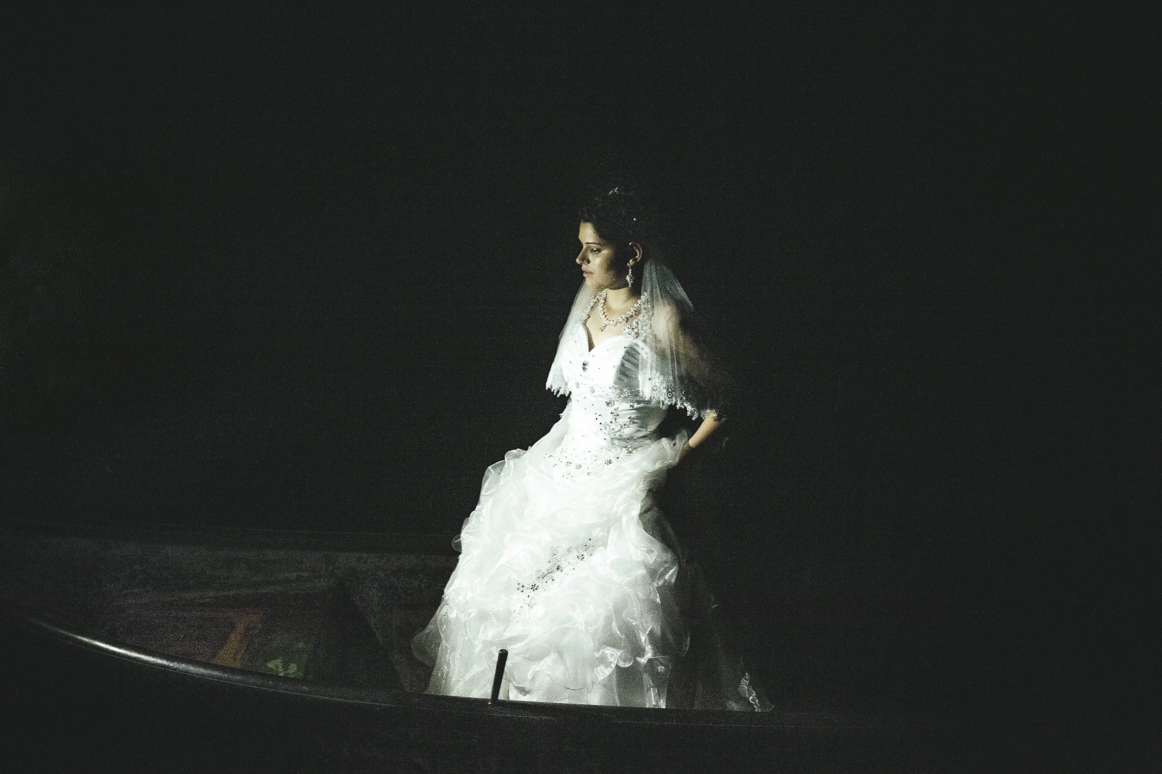 Abduction of the bride, she is standing on a little boat on the channel, Letea, Romania, 2015