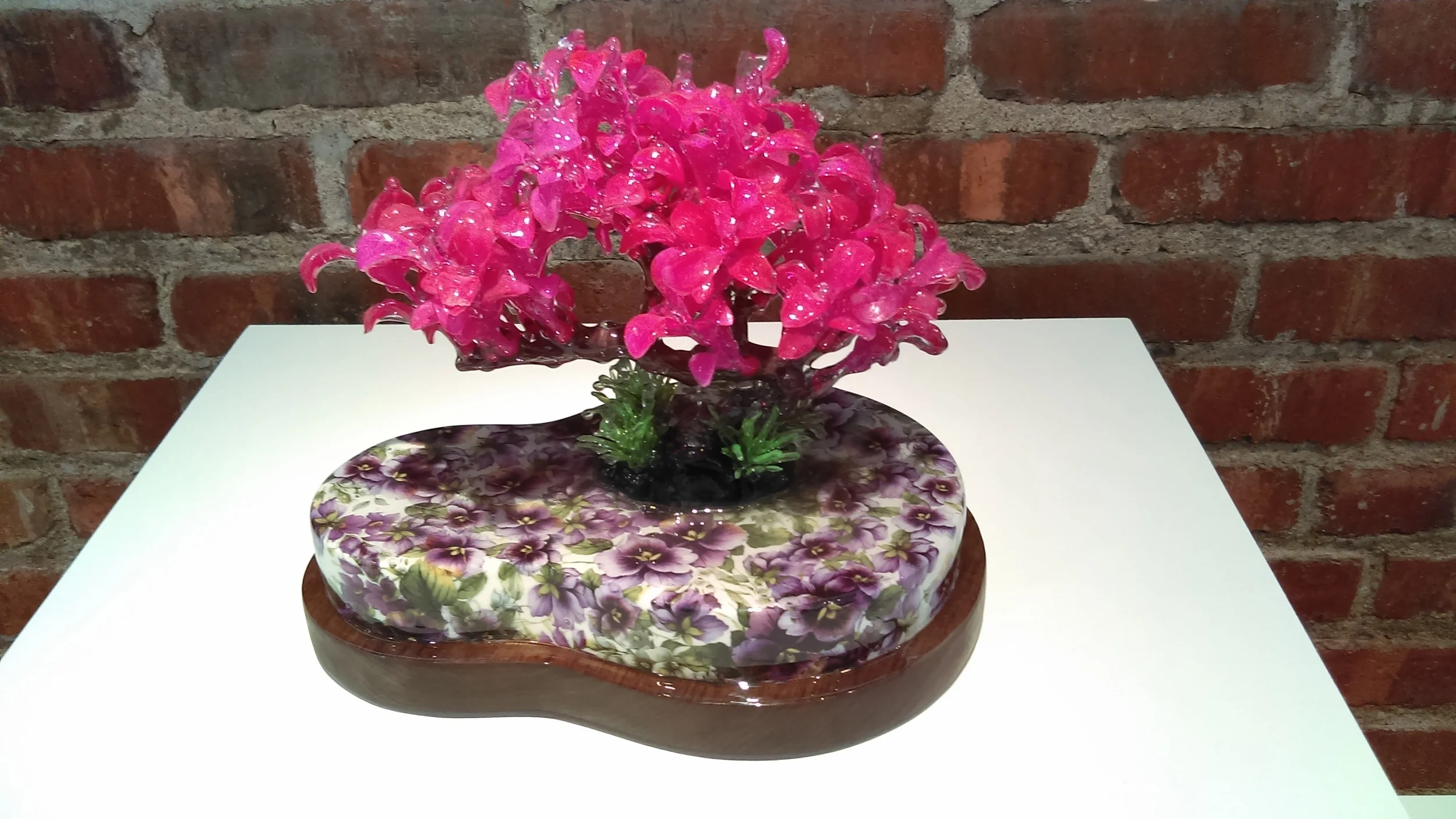 Bon Mot Rain Harris , 2016, (porcelain, walnut, plastic tree, resin, decals). I love the color play with the distinct air of “fakeness” playing with the japanese bonsi motif. A Bon Mot is a witty remark.